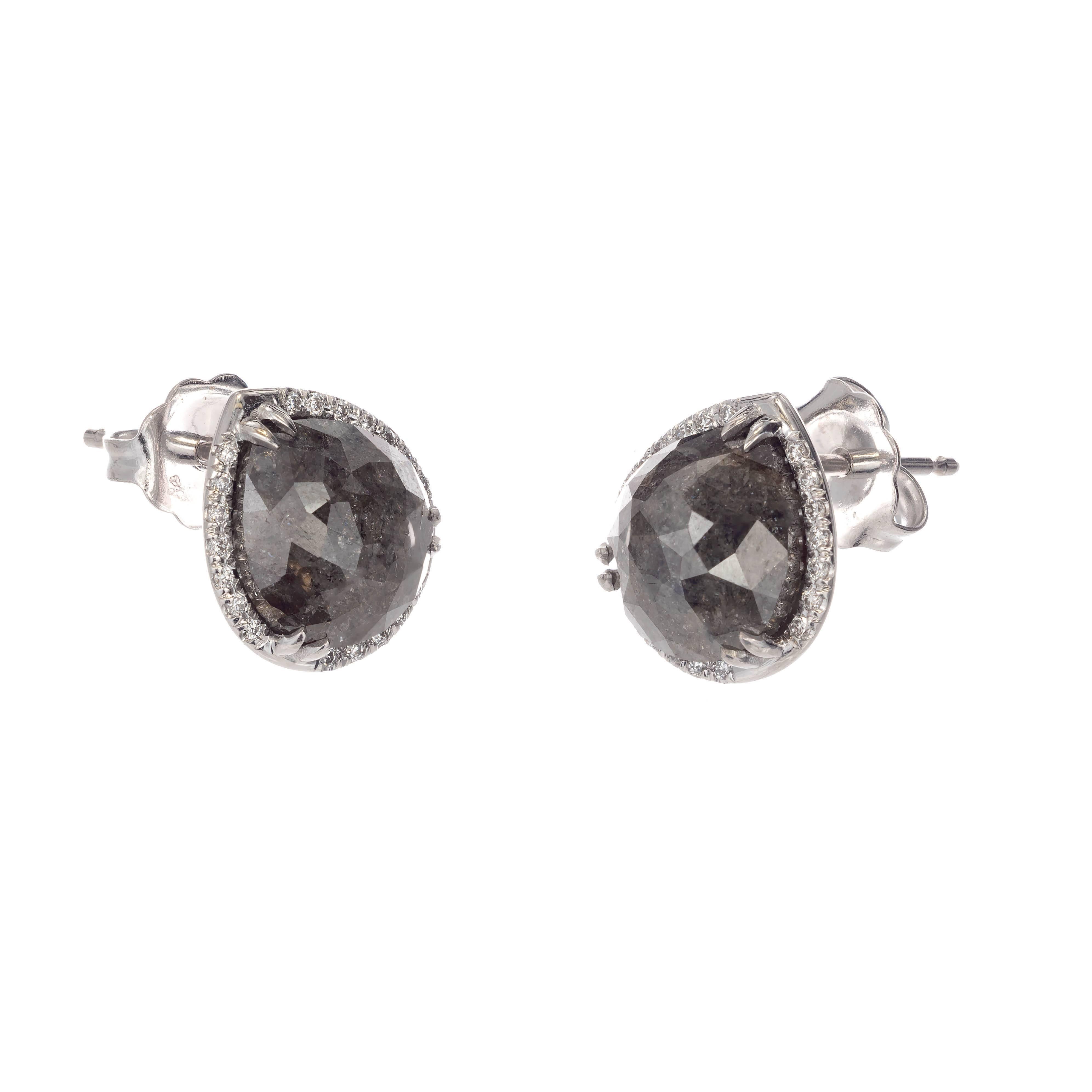 18k white gold dark gray diamond stud earrings. A pair of natural, fancy dark gray pear shape, rose cut diamonds are set in a halo of white round brilliant cut diamonds.

1 pear rose cut fancy dark gray diamond 8.52 x 7.31 x 3.48 Approximate 1.87