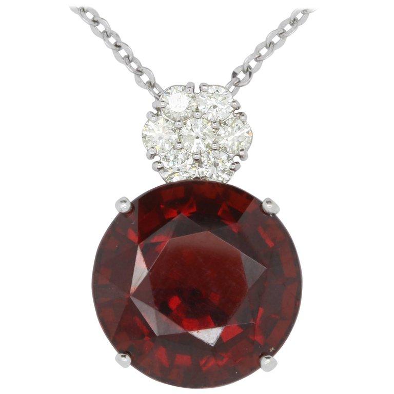 Material: 14k White Gold 
Center Stone Details: 34.70 Carat Round Rhodolite Garnet - 20.2 mm
Diamonds:  7 Round Diamonds at 1.20 Carats.  SI Quality /  H-I Color
Chain:  18