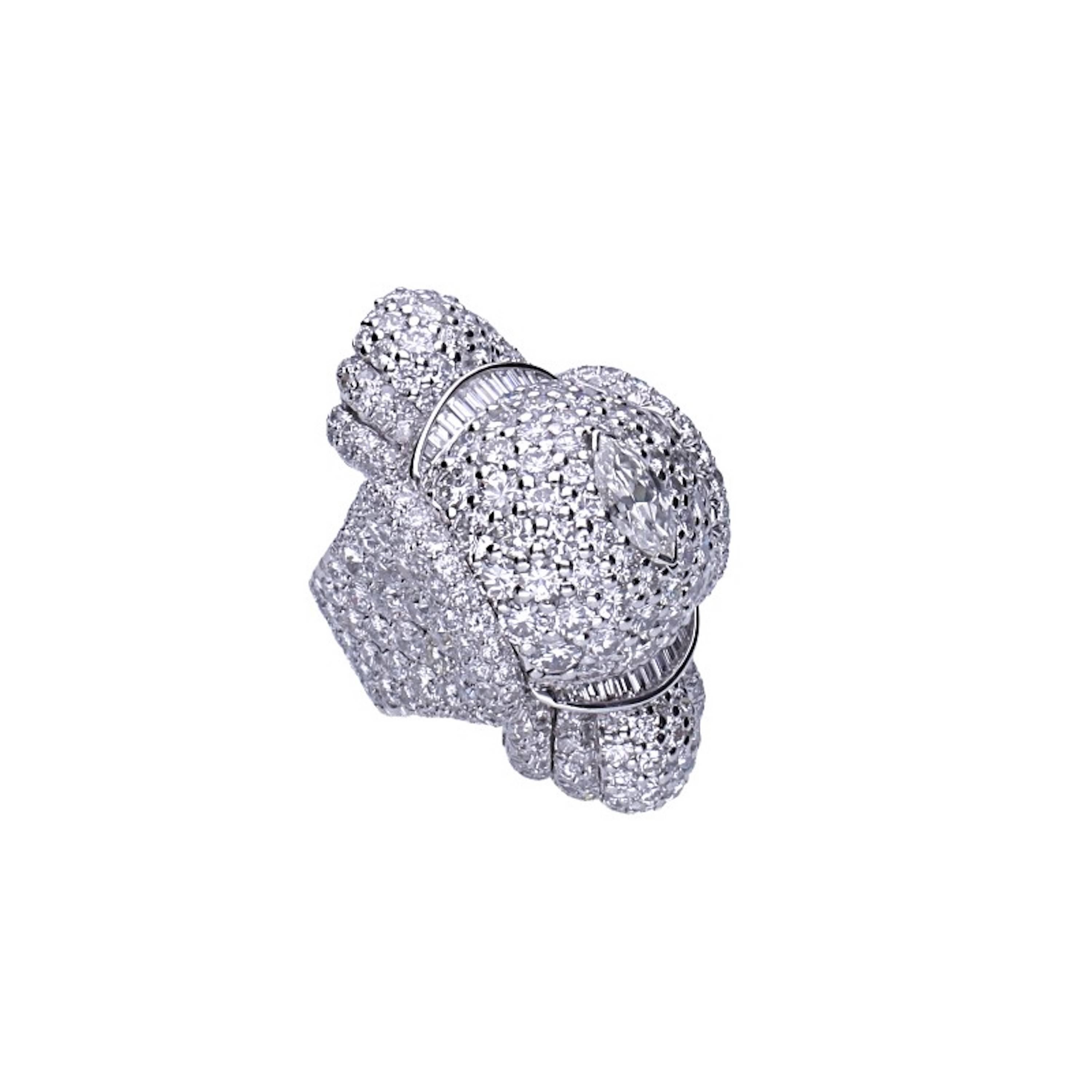 Platinum and 18 kt. white gold ring with navette, baguettes and round-cut diamonds.
Navette diamond: 1.45 carat
Baguette diamond: 1.30 carat 
Round-cut diamonds: 32.00 carats 
Exceptional platinum ring ca 1940, completely hand-made.
Weight: gr.