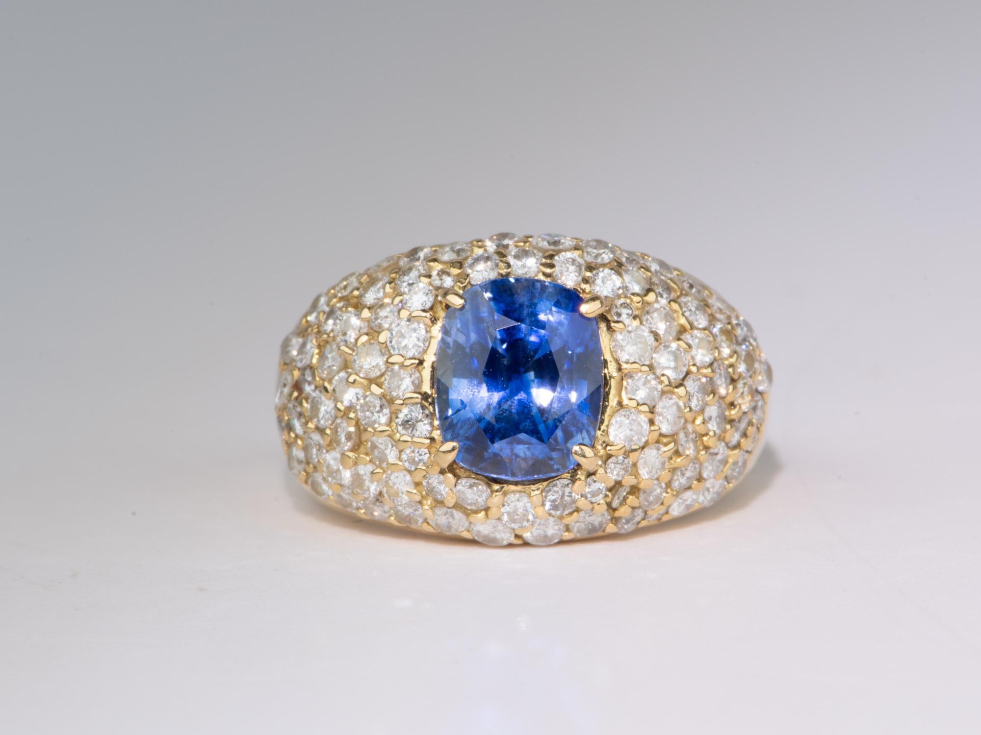   Make a timeless statement with this 3.47ct Sapphire Wide Band Ring with Diamond Pave! Crafted with a breathtaking cornflower blue sapphire in the center in a dome top style, this one-of-a-kind piece will have everyone turning heads for its classic