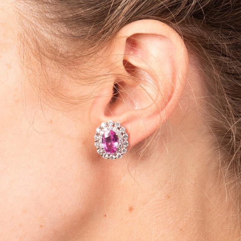 These beautiful stud earrings feature 3.47 carat total weight in oval pink sapphires surrounded by a double halo in 2.11 carat total weight round diamonds set in 18 karat white gold. Friction post with butterfly back.
Measurements: Approximately