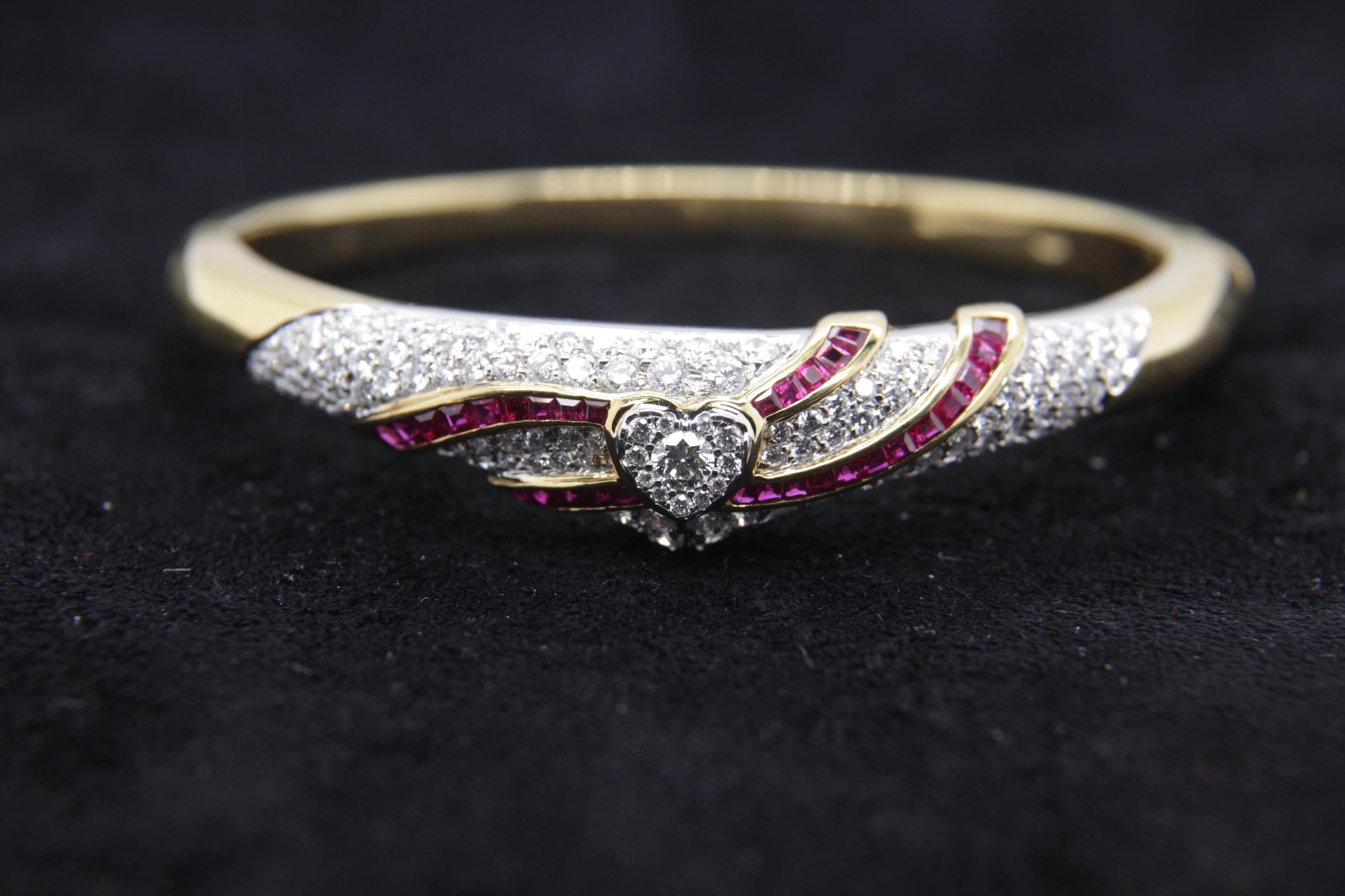 A brand new diamond and ruby bangle in 18 karat gold. The total diamond weight is 3.48 carats and ruby weight is 1.49 carats. The total bangle weight is 31.67 grams.
