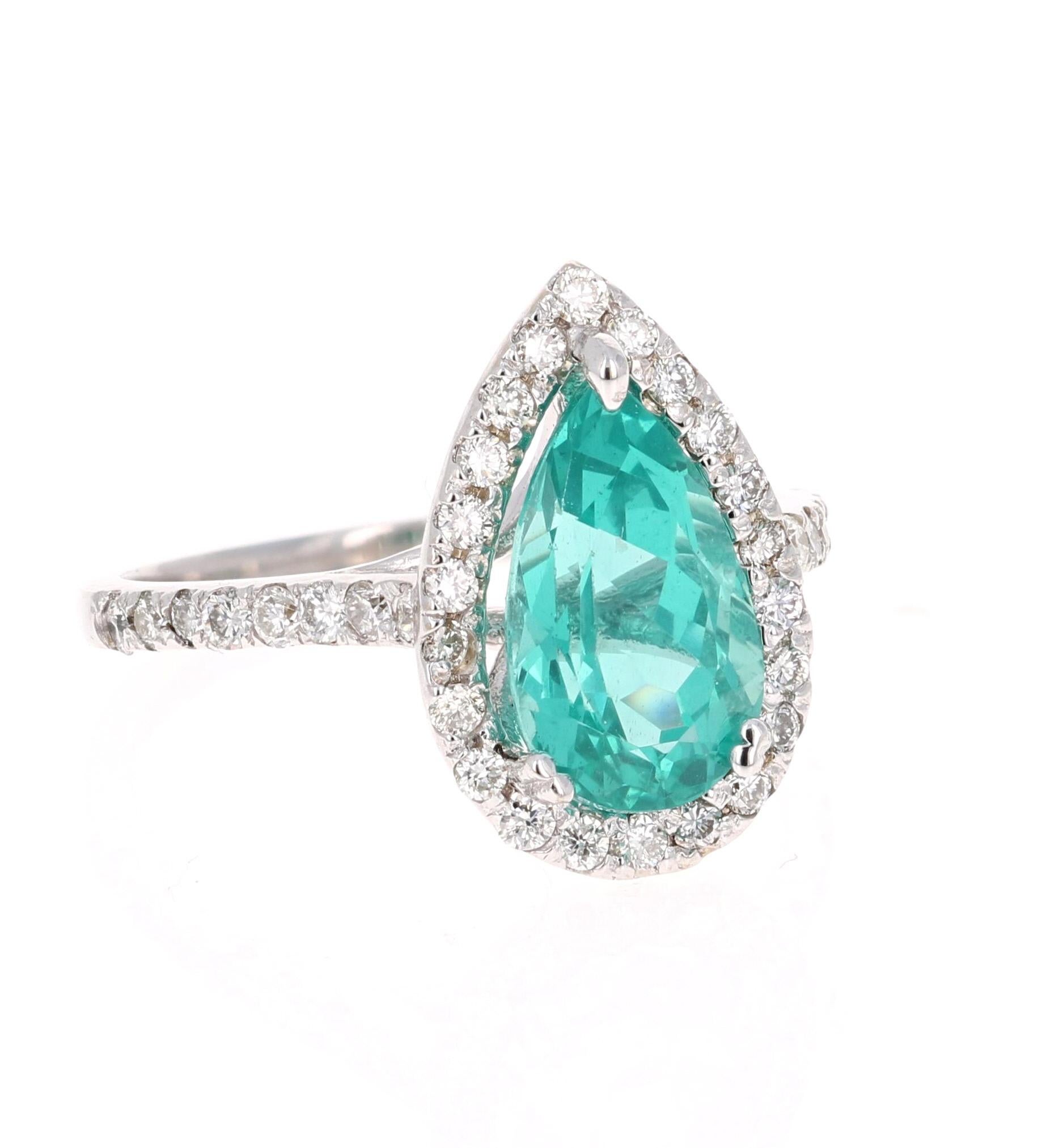 Gorgeous Halo Apatite and Diamond Ring.  This ring has a 2.89 Carat Pear Cut Apatite in the center of the ring and is surrounded by a halo of 36 Round Cut Diamonds that weigh 0.59 carat (Clarity: SI2, Color:F).  The total carat weight of the ring is