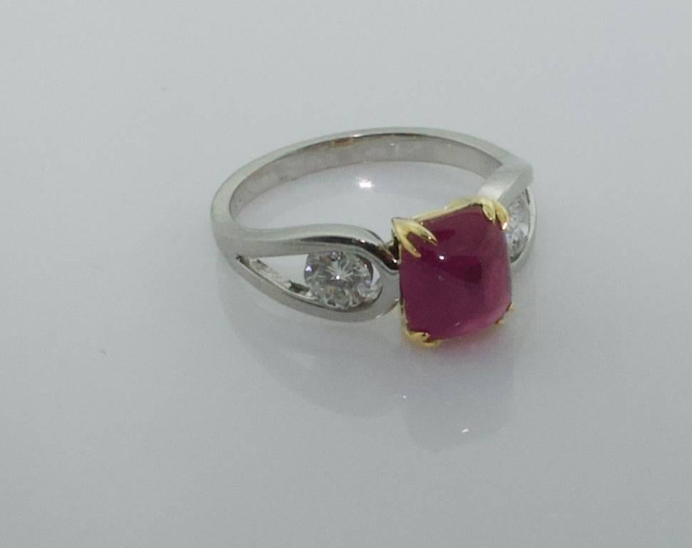 3.48 carat Ruby and Diamond Solitaire Ring in Platinum and 18k 
A Lively 3.48 carat Cushion Cabochon Ruby [bright with no imperfections visible to the naked eye]
Twi Round Brilliant Cut Diamonds weighing .50 carats [GH SI1]  [no imperfections