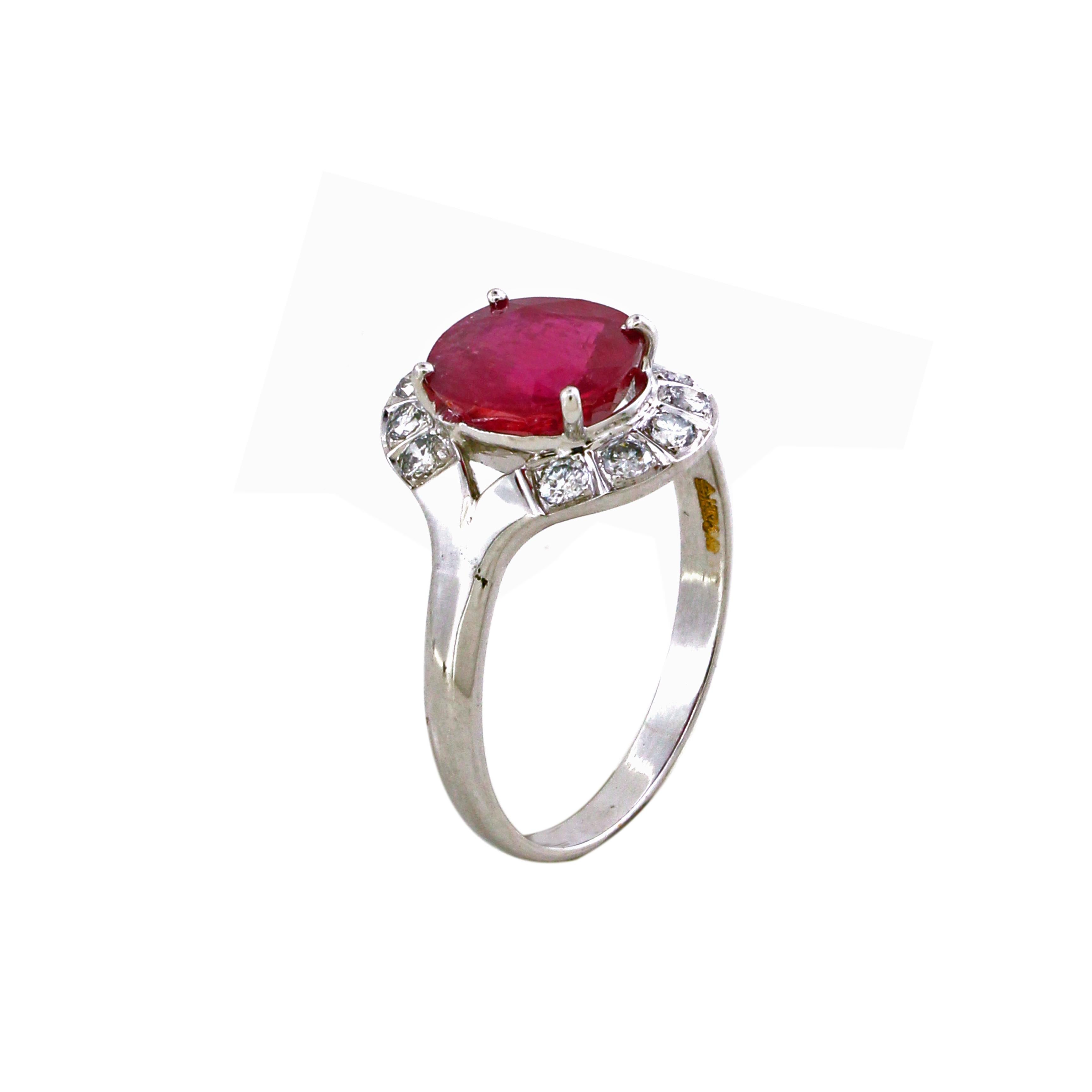 Behold the allure of our Oval Ruby Halo Diamond Ring, a mesmerizing masterpiece in sophistication and grace. At its heart, a stunning 3.48-carat oval-shaped ruby commands attention with its rich, deep red hue—an embodiment of passion and timeless