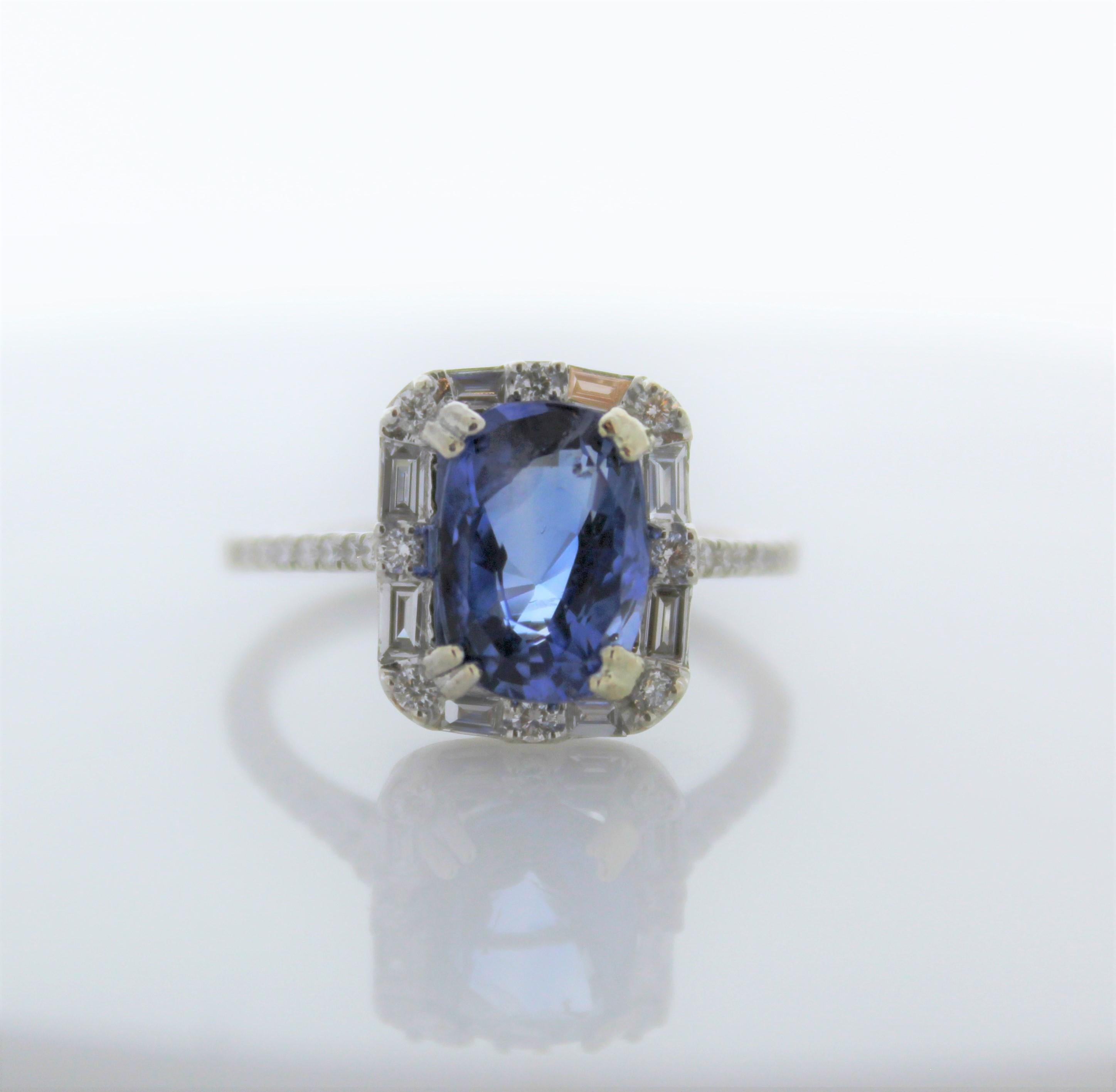 This is a 3.48 carats vibrant royal blue sapphire takes center stage on this luxurious setting. Its gem origin is Sri Lanka. It is polished and faceted to a cushion cut. Its color, transparency, and luster are excellent. A total of 34 round