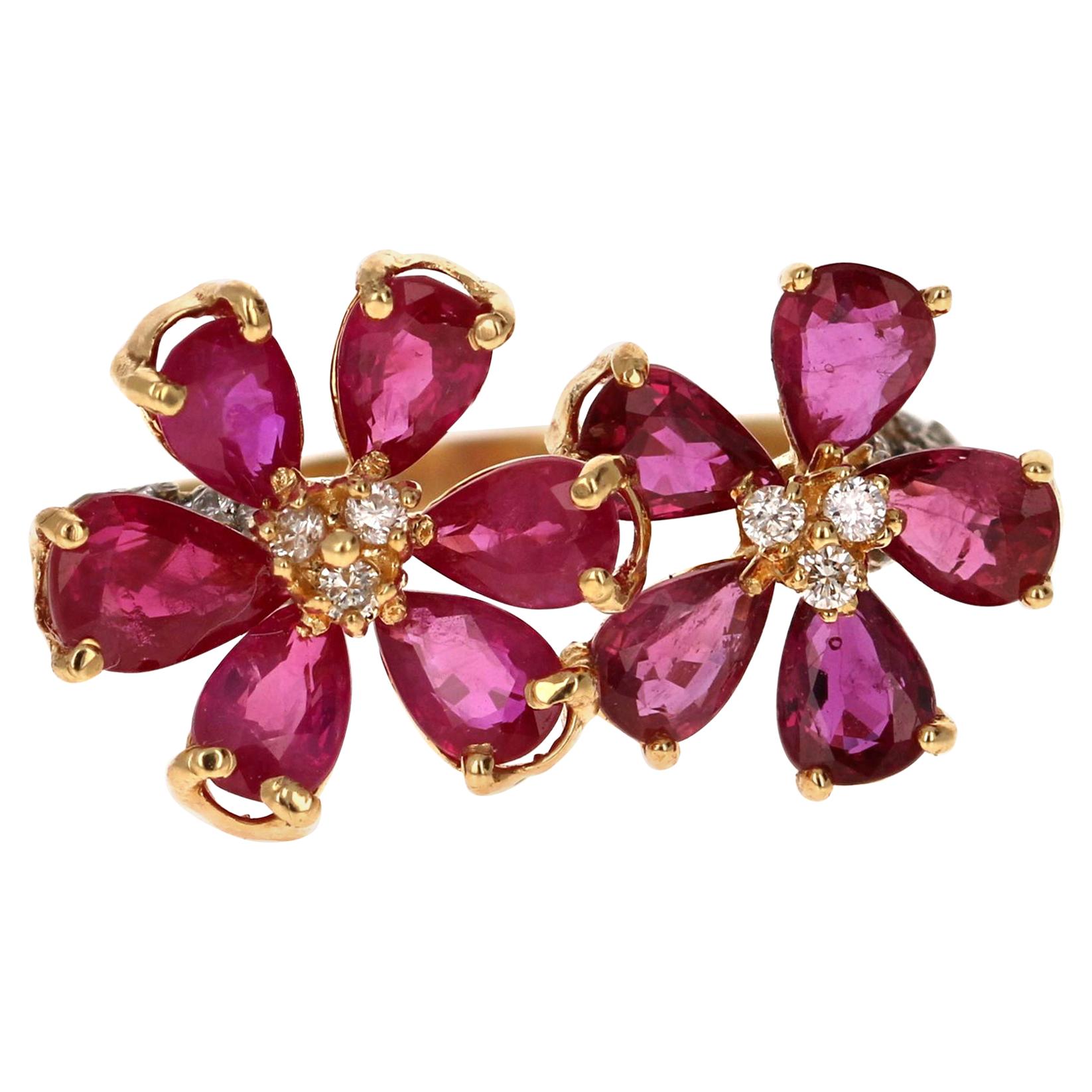 This charming Ruby Diamond Yellow Gold Ring is a modern cocktail ring that is sure to get a lot of attention with its unusual flow and design. 

There are 11 Natural Pear Cut Burmese Rubies that weigh a total of 3.12 Carats.  The Rubies are accented