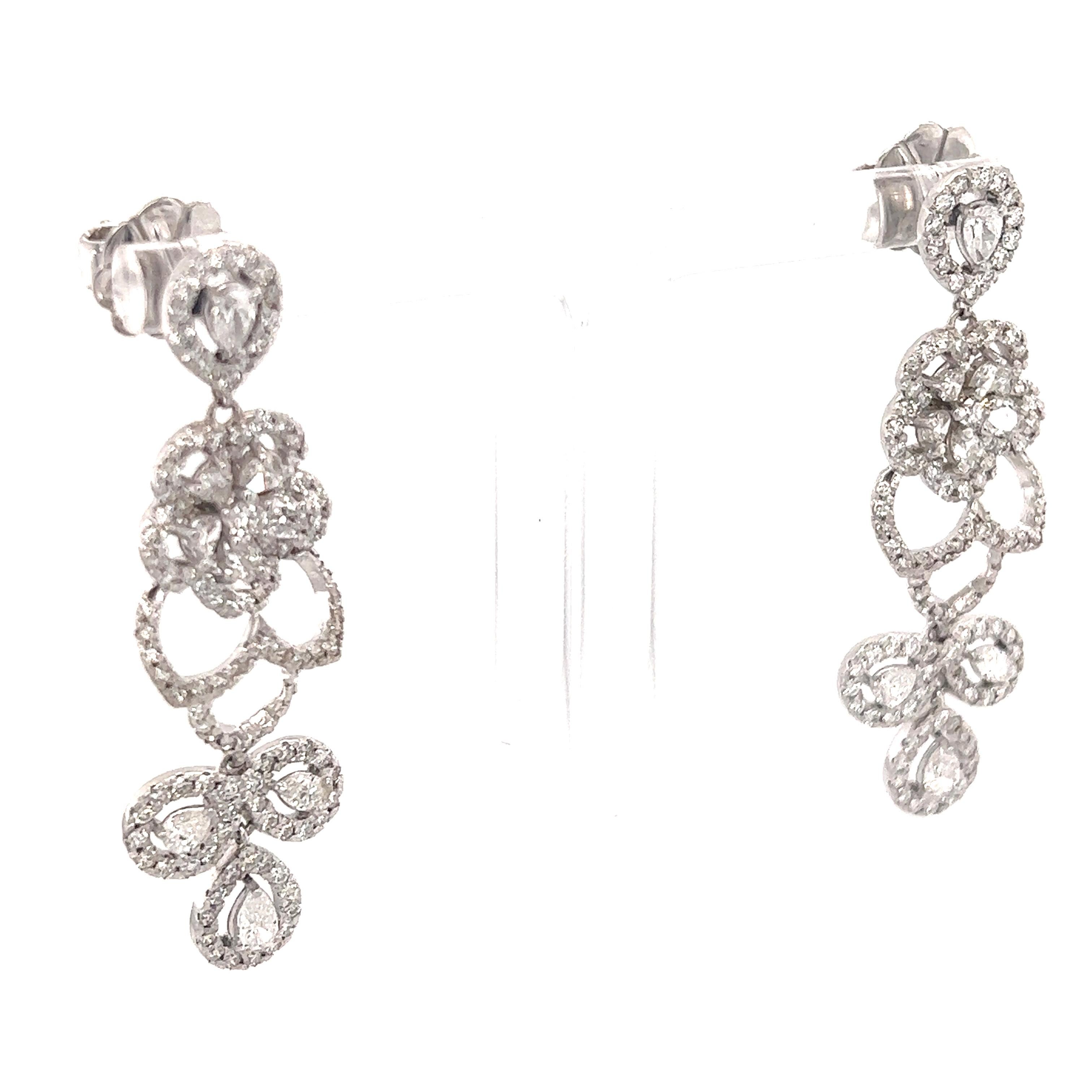 These earrings have Natural Pear Cut White Diamonds that weigh 1.44 carats and Natural Round Cut White Diamonds that weigh 2.05 carats. The total carat weight of the earrings are 3.49 carats. 

The clarity and color of the earrings are VS-F. 

They
