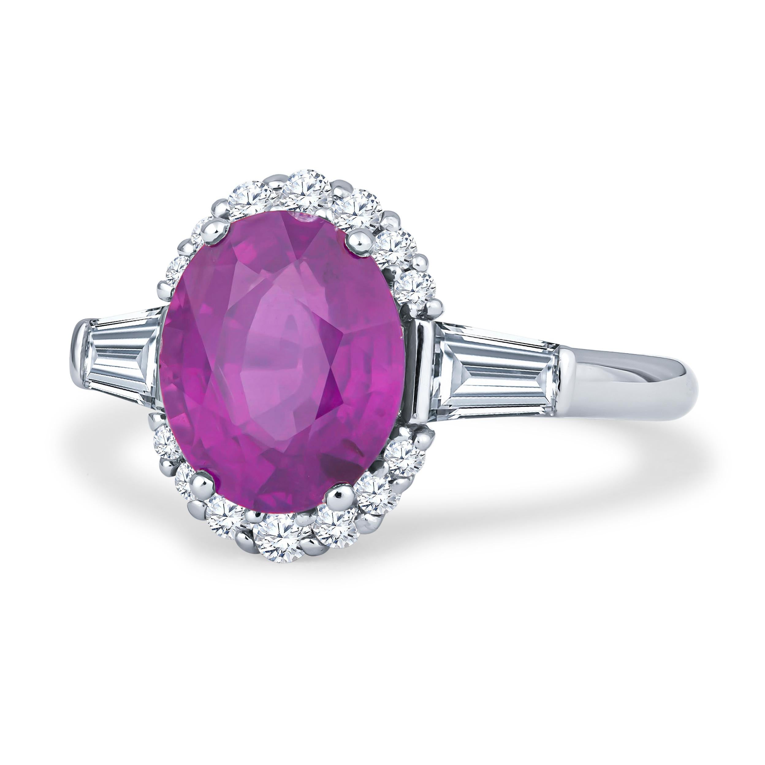 This absolutely gorgeous 3.49ct no heat oval pink natural sapphire comes from Sri Lanka and is set in a platinum ring with two 0.58ct total weight in tapered baguette diamonds, as well as 0.36ct total weight in round brilliant cut diamonds. The