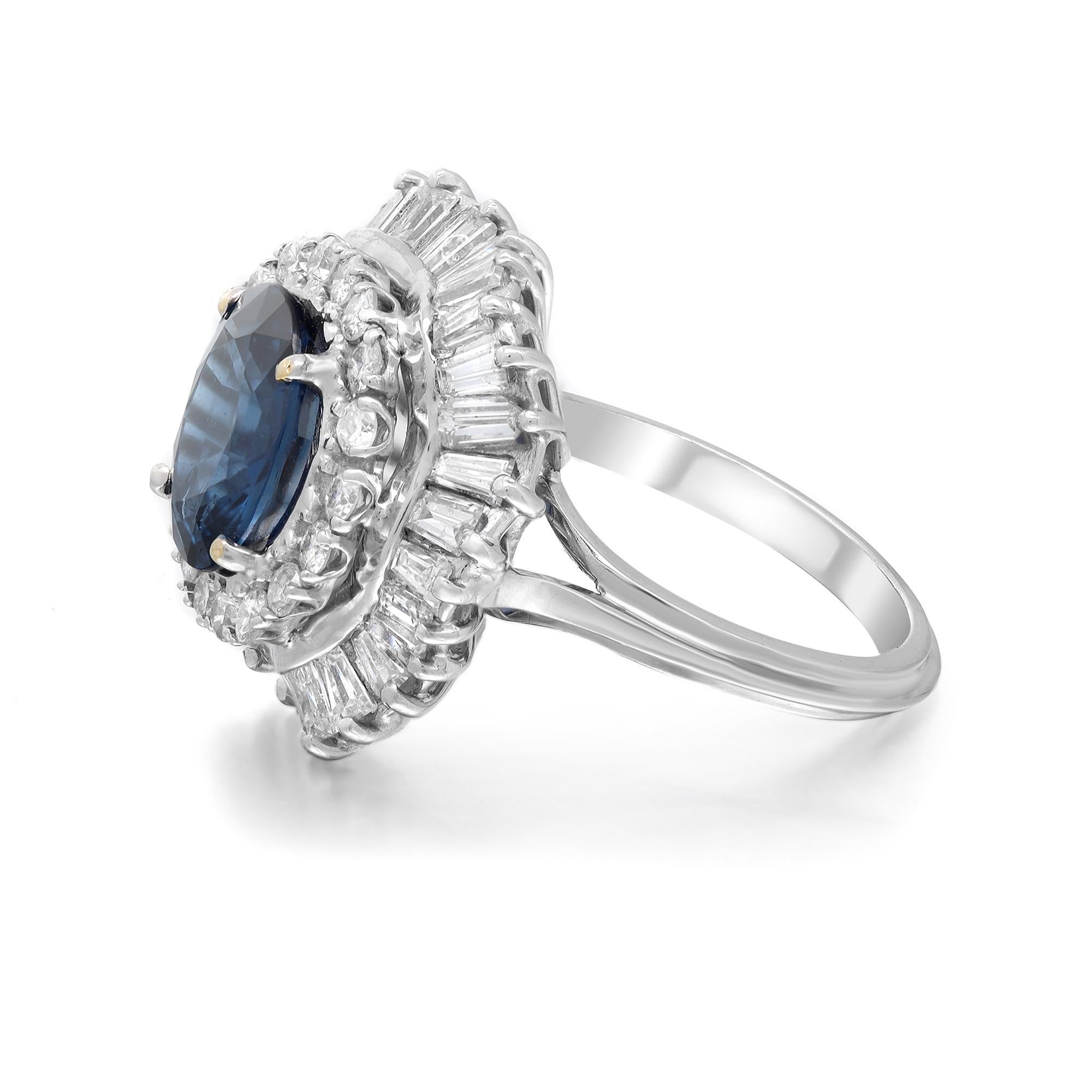 This gorgeous cocktail ring is crafted in 14k white gold. The center prong set oval shape blue sapphire weighing 3.49 carats is illuminated by a sparkling halo of round cut and baguette cut diamonds weighing approx. 2.35 carats. Diamond quality: