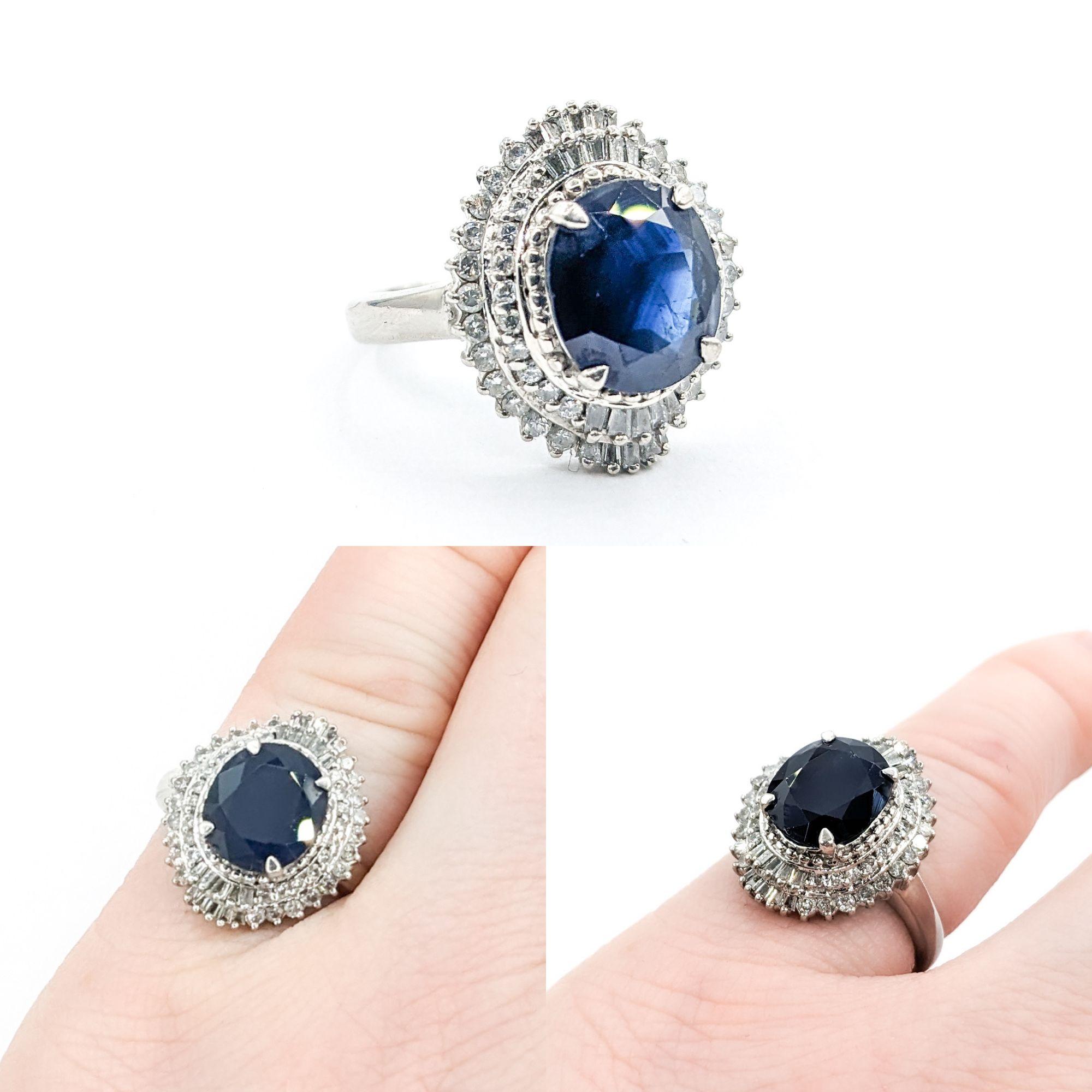 3.4ct Blue Sapphire & Diamond Ring In Platinum

Introducing an exquisite Gemstone Fashion Ring, masterfully crafted in 900pt Platinum. This captivating piece showcases a stunning 3.4ct Sapphire centerpiece, complemented by .60ctw of Round & Baguette