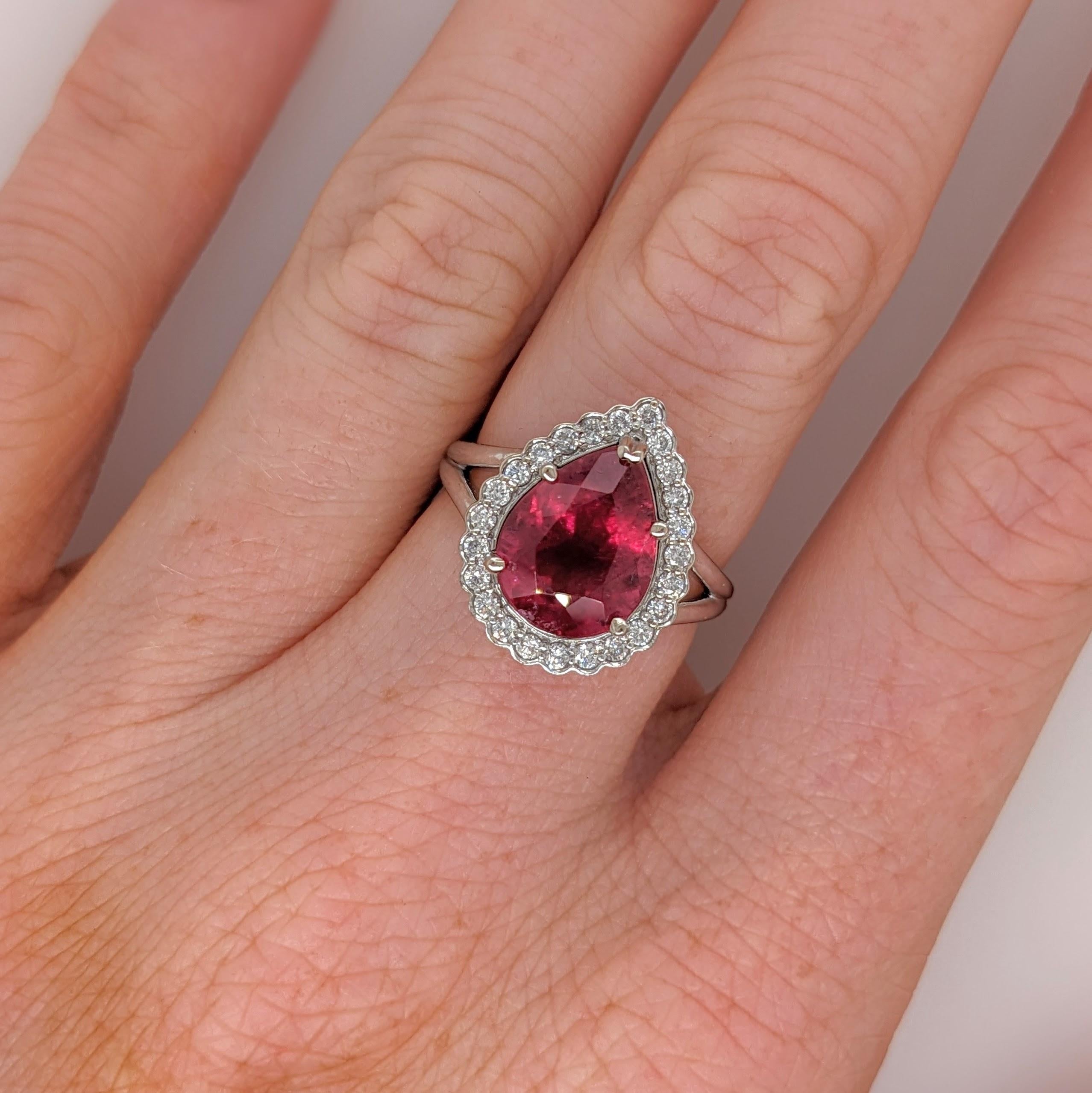 This beautiful ring features a 3.48 carat pear shape rubellite tourmaline gemstone with a halo of natural earth mined diamonds, all set in solid 14K gold. This ring can be a beautiful October birthstone gift for your loved ones!