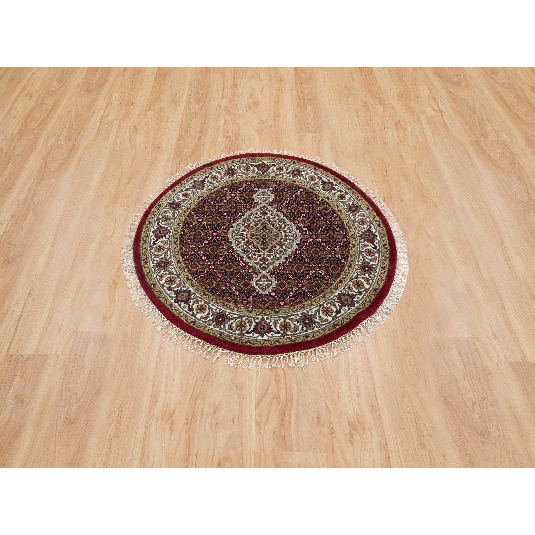 Mahogany Red, Tabriz Mahi with Fish Medallion Design, Pure Wool, 175 KPSI, Hand Knotted, Round, Oriental Rug
Primary materials: Wool
Latex: No Pile 
height: 0.25 Inches
Style: Traditional
Primary color: Red
Secondary colors: Gray, Green, Brown,