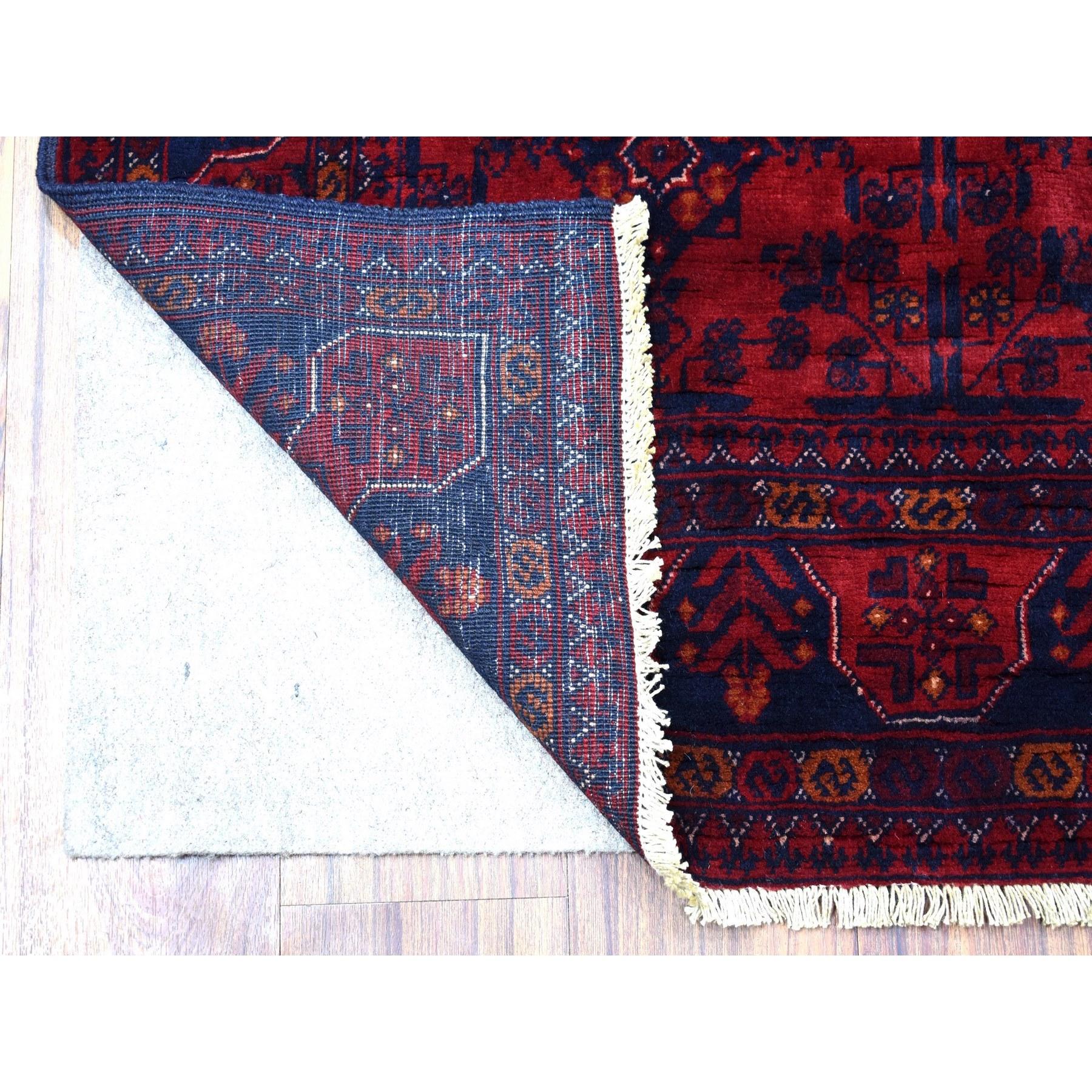 This is a truly genuine one-of-a-kind Afghan Khamyab with Geometric Medallions Design Hand Knotted Deep and Saturated Red Pure Wool Oriental Rug. It has been Knotted for months and months in the centuries-old weaving craftsmanship techniques by