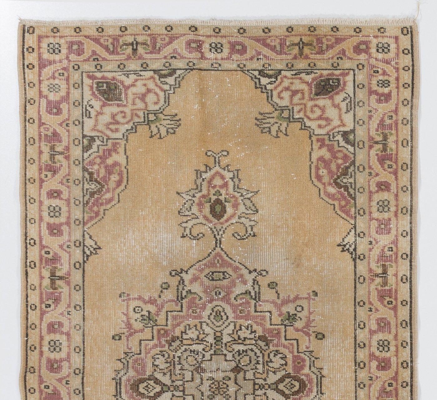 A finely hand-knotted vintage Turkish carpet from 1960s featuring an elegant medallion design. The rug has even low wool pile on cotton foundation. It is heavy and lays flat on the floor, in very good condition with no issues. It has been washed