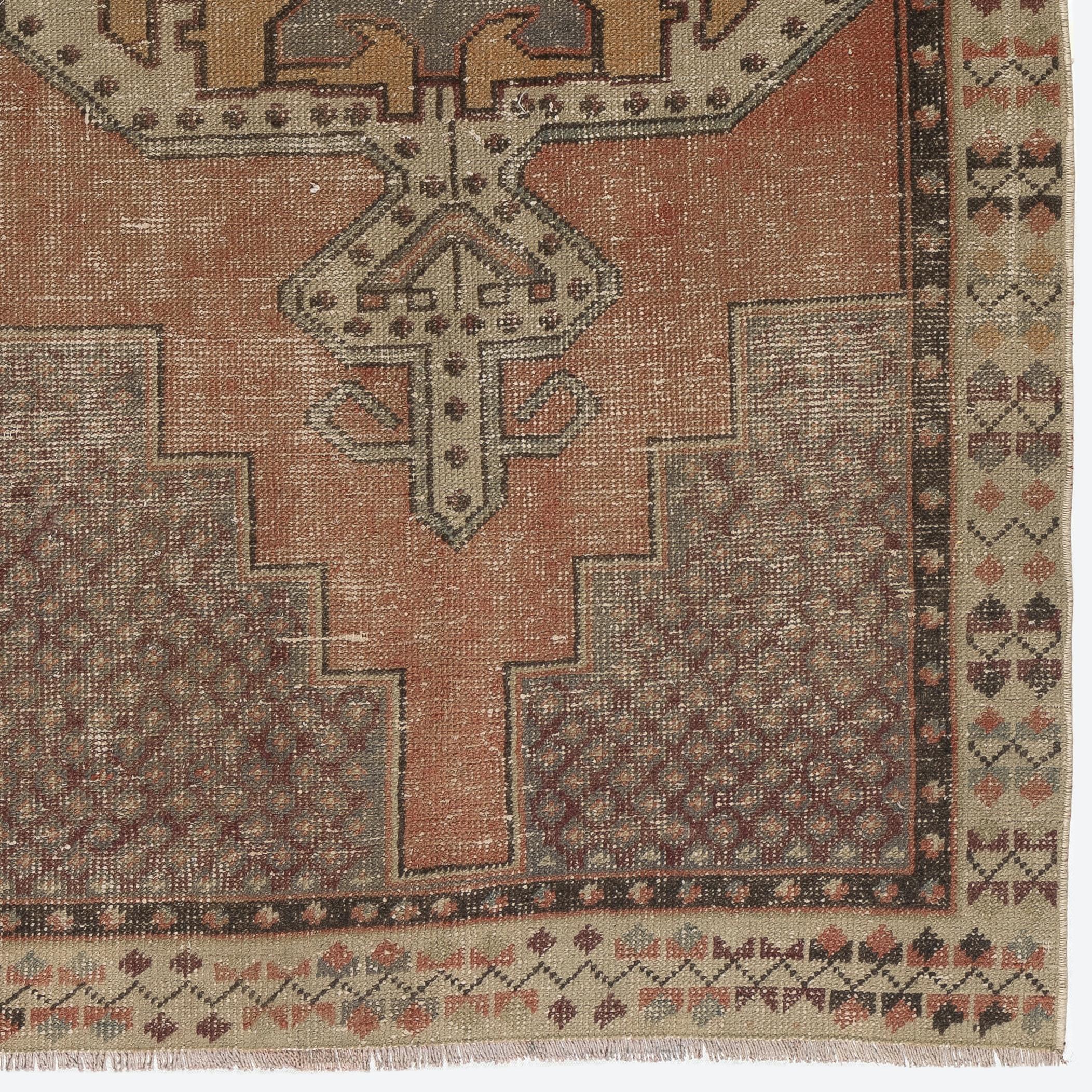 A finely hand-knotted vintage Turkish carpet from 1950s featuring a geometric medallion design. The rug has even low wool pile on cotton foundation. It is heavy and lays flat on the floor, in very good condition with no issues. It has been washed