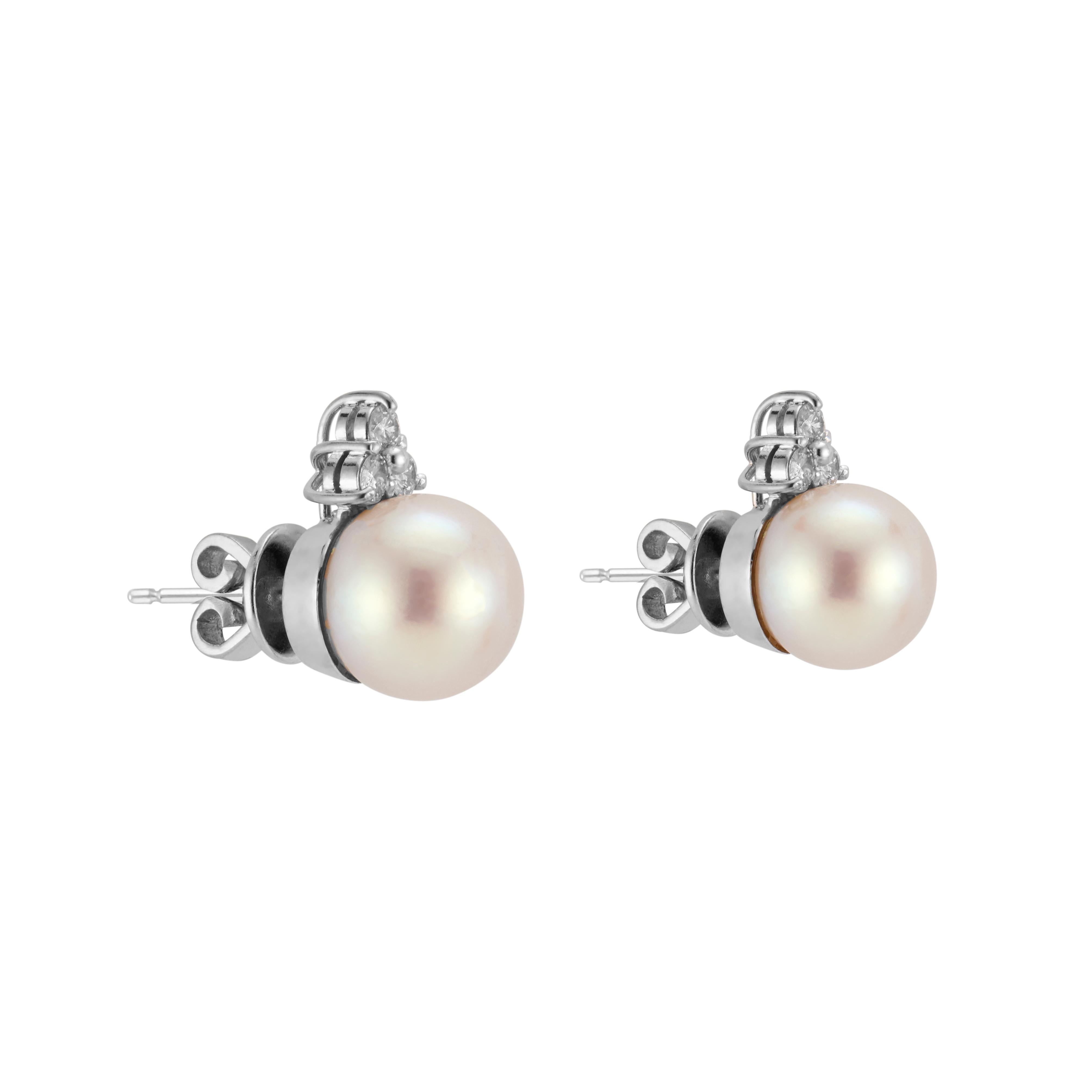 1960's Cultured pearl and diamond stud earrings. 2 Akoya pearls accented with 6 round brilliant cut diamonds in 18k white gold settings. The pearls have excellent lustre, few blemishes, cream overtone. 

2 Akoya white creme hue cultured pearls,