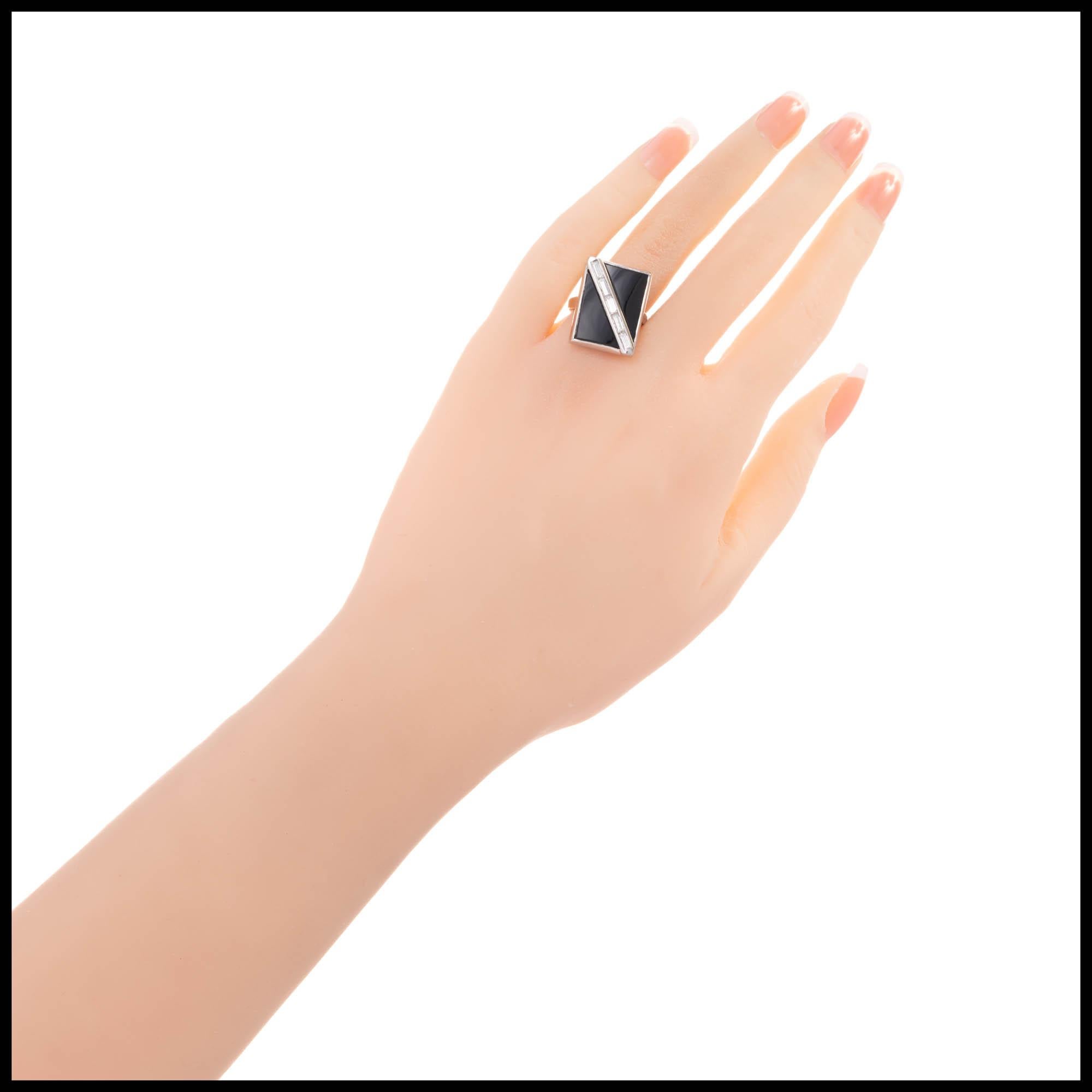 Vintage black onyx and diamond ring. Triangular cut black onyx facing each other with a diagonal row of baguette diamonds set in between the onyx all in a 14k white gold setting.

2 triangular cut black onyx 14 x 9 mm
5 baguette I-J VS diamonds