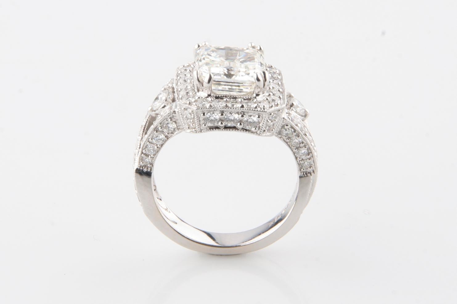 Gorgeous Solitaire Ring w/ Huge Emerald Cut Solitaire Diamond
Weight of Center Stone = Approximately 3.5 Carat
Dimensions: 9.17 mm Long x 8.11 mm Wide
Color: J
Clarity: SI-2
Approximately 1 Carat Accent Stones
Average Color: I
Average Clarity: