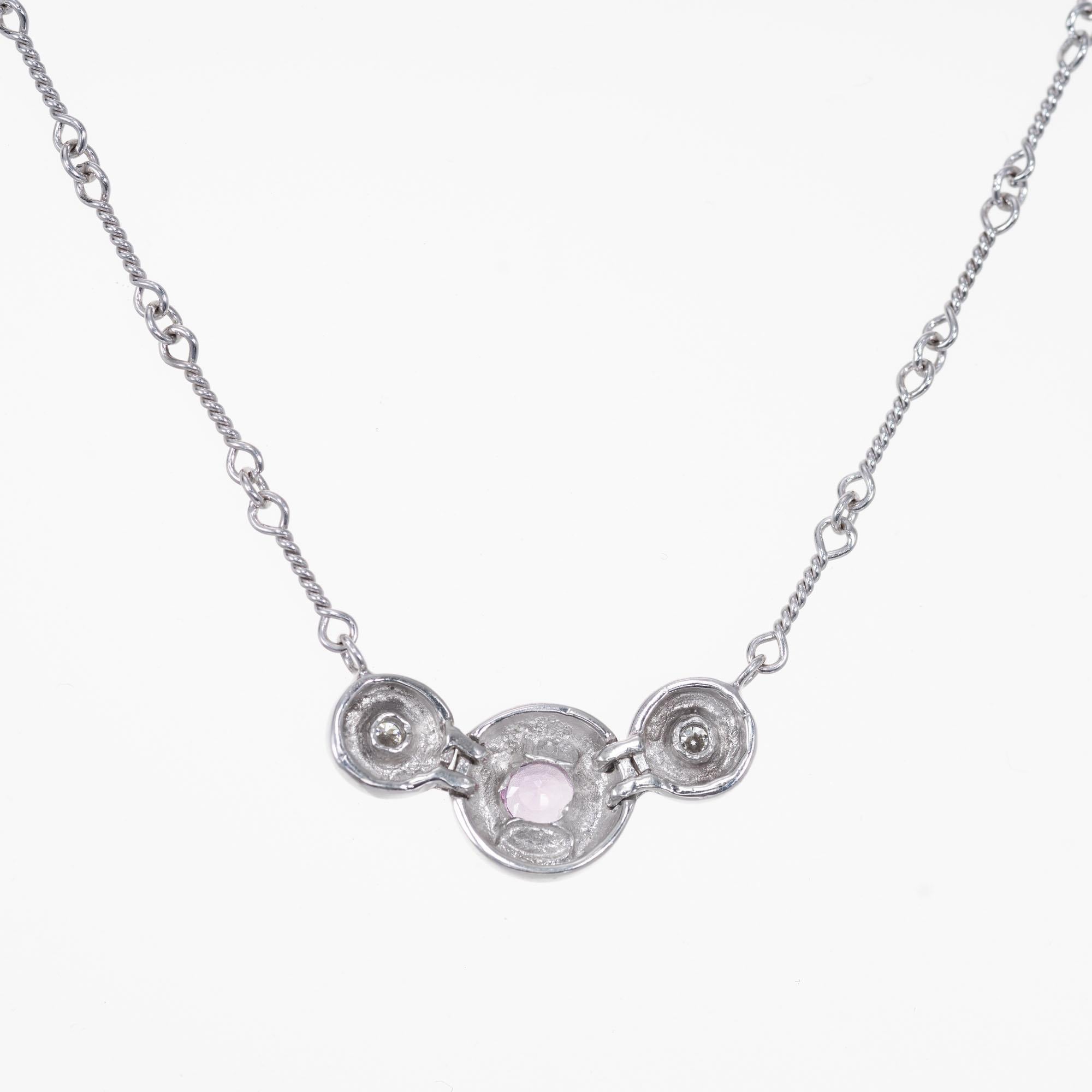 Pink sapphire and diamond pendant necklace. GIA certified pink round center stone set in 14k white gold with 2 round brilliant cut side diamonds. Wire bar link chain 15.5 inches. 

1 pink sapphire, approx. total weight .35cts, VS, 4.0mm, natural