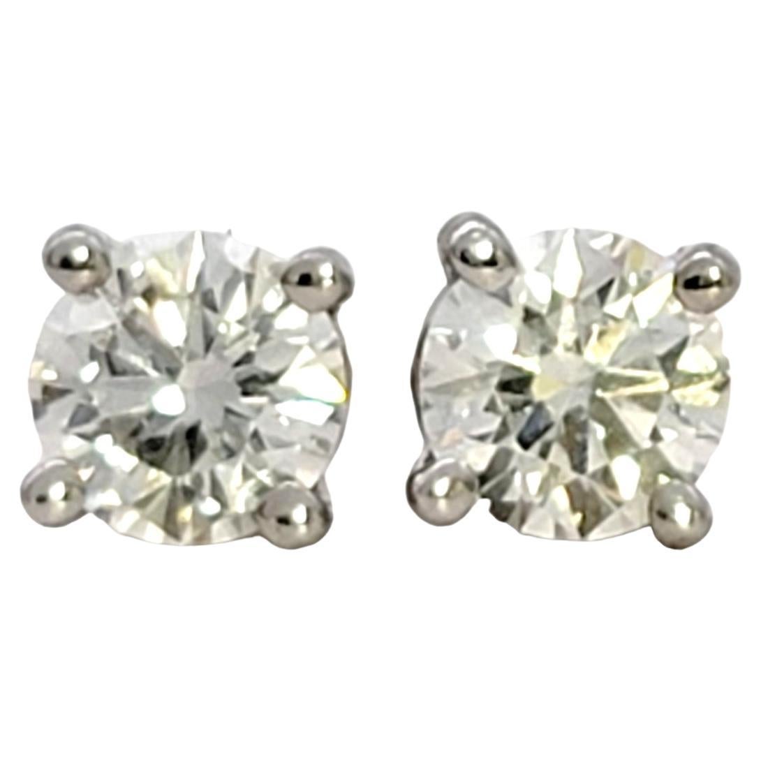 Utterly timeless diamond solitaire stud earrings from renowned jeweler, Tiffany & Co. Founded in 1837 in New York City, Tiffany & Co. is one of the world's most storied luxury design houses recognized globally for its innovative jewelry design,