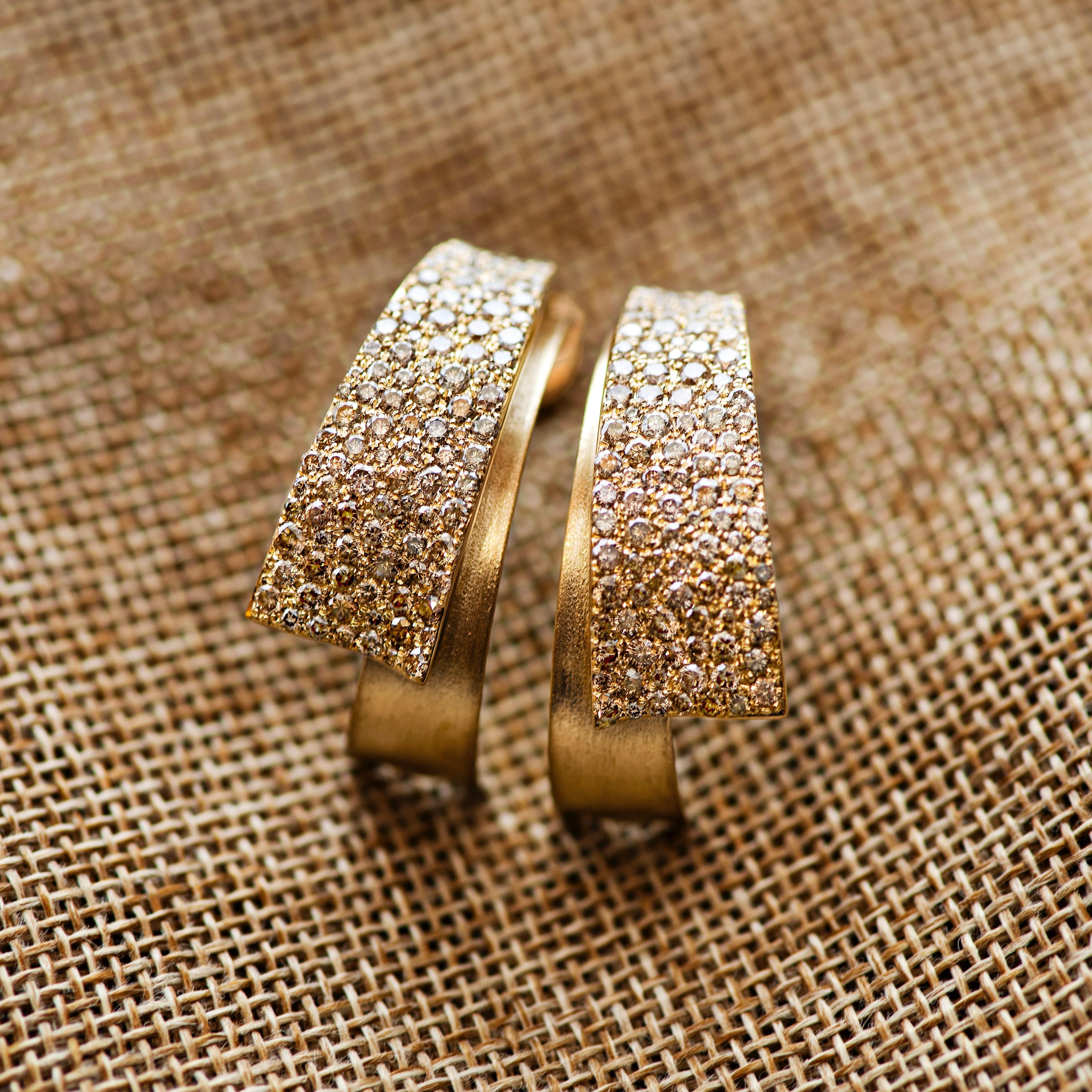 Glow collection by D&A - a fine jewelry collection that shows mix of diamonds in micro pave setting and stylish designs. 
These earrings are really something special - small white and champagne diamonds make it very bright and sparkling. It is very
