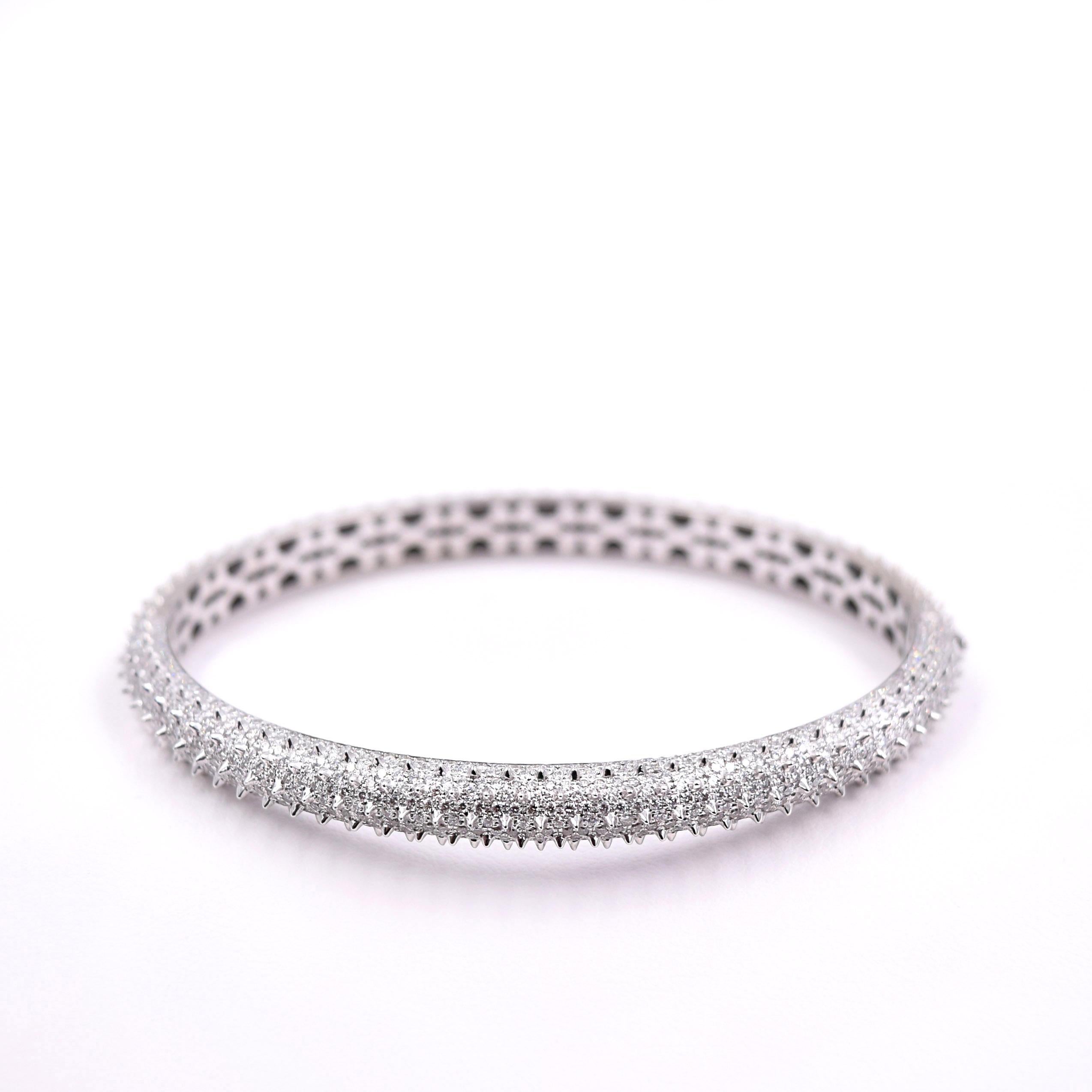 One of a kind 18k white gold spike bangle bracelet with 636 white diamonds totaling 3.5 carats.
Made to order. All diamonds set by hand - please allow two weeks.