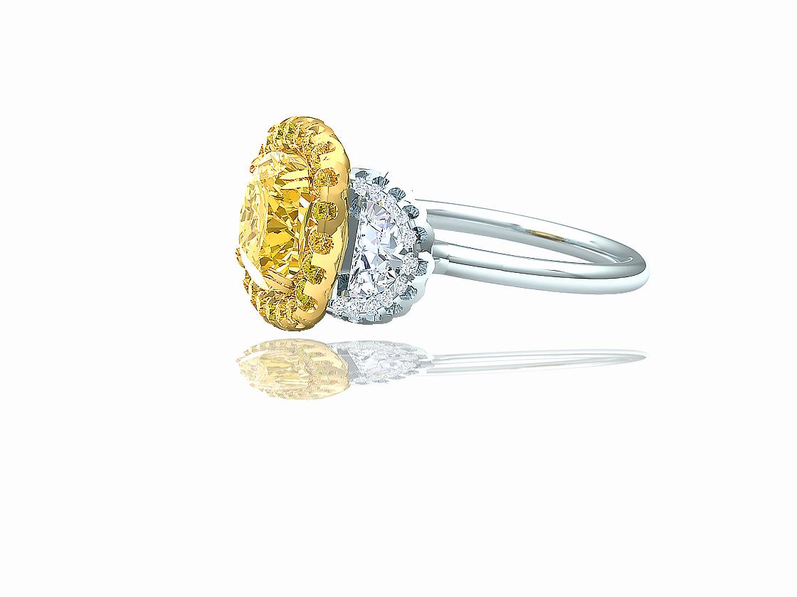 This stunning ring contains the following.  One cushion cut diamond thats fancy yellow in color and VS clarity.  The center diamond is aprrox. 2.4-2.5 carats and is GIA certfied Fancy Yellow and VS clarity.  The center diamond is complimented by .20