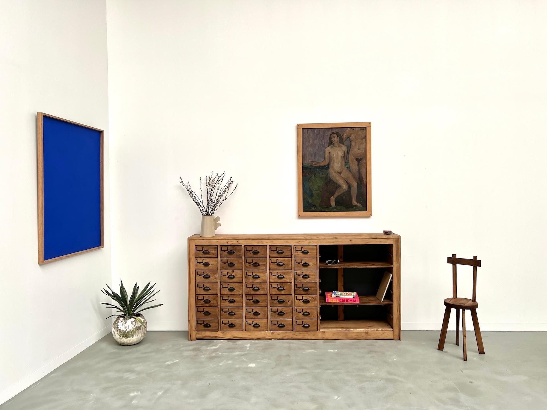 Maison Lecan presents this fully restored pine storage cabinet with raw, authentic charm.

Featuring 36 drawers with aged metal cup handles and a side shelving unit, it perfectly balances vintage style and practicality. Originally designed as a