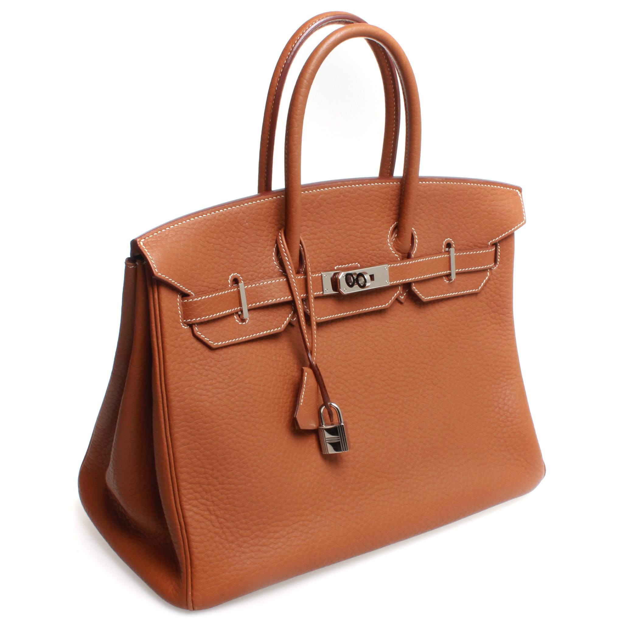 This Hermes Birkin Handbag Gold Togo with silver Hardware 35, crafted from Gold brown togo leather, features dual rolled handles and front flap. Its turn-lock closure opens to a gorgeous leather interior with slip pocket.

Date stamp reads: K in a