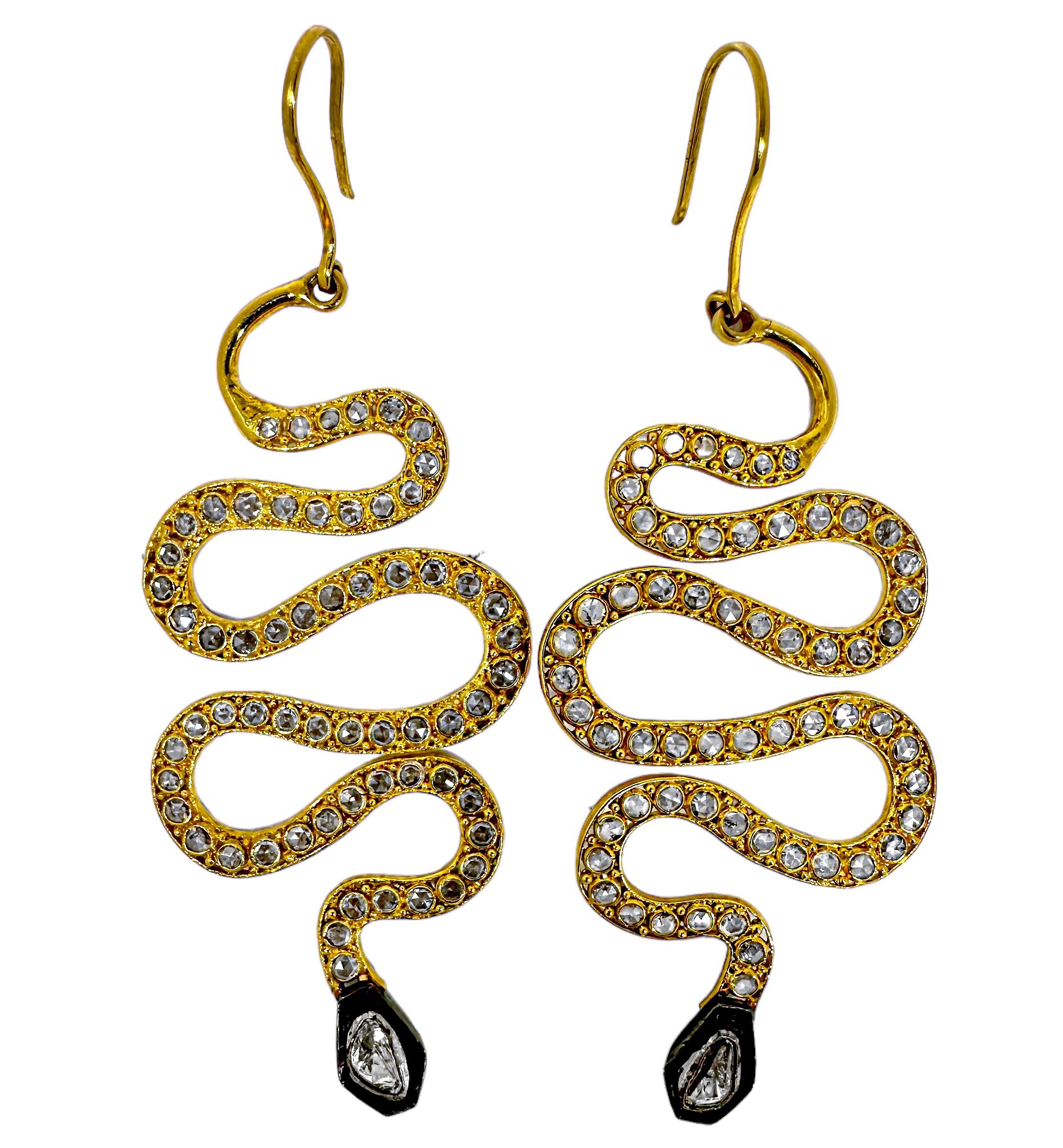 This stylish and contemporary pair of serpentine earrings measure a full 3 1/2 inches in length by 1 3/8 inches in width. The bezel set rose cut diamonds over the entire length plus the two larger rose cut diamonds set in oxidized plates at the
