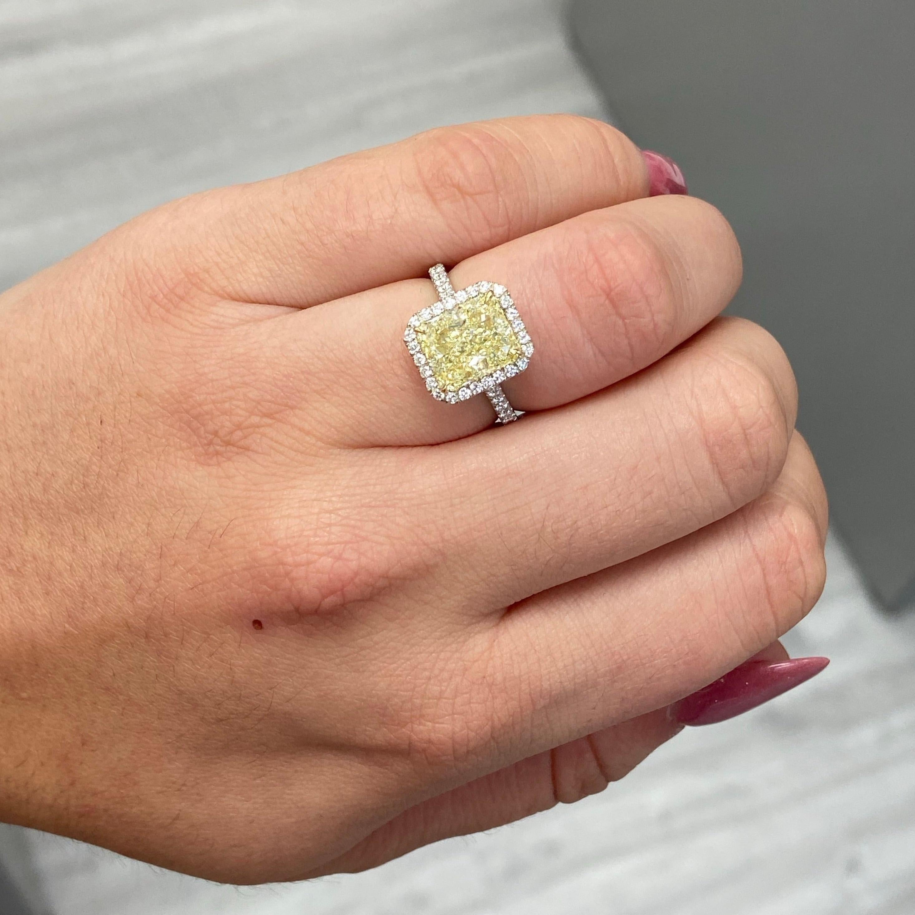 Vibrant and lively 3.50 Carat 
GIA WX 
Radiant Cut
VS2 Clarity 
Surrounded by .65 Carats of White Rounds
Handmade in NYC 
Set in Platinum
Size 6.5
