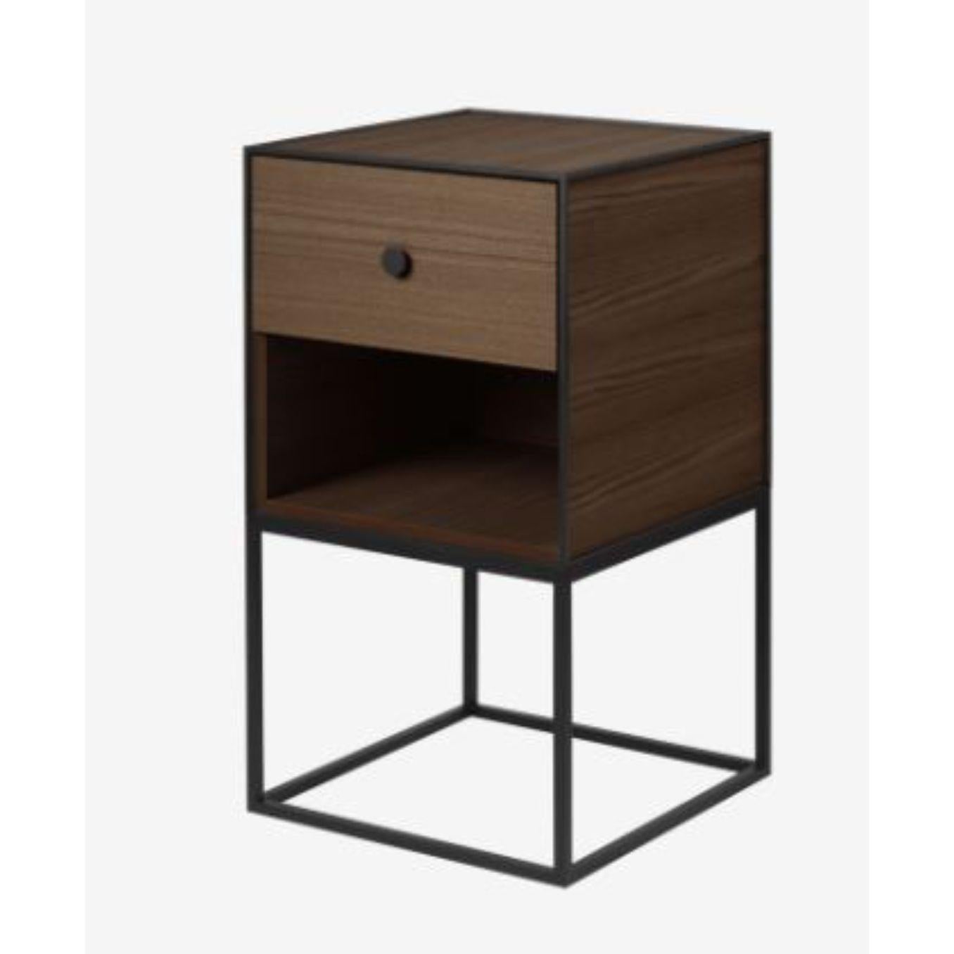 35 smoked oak frame sideboard with 1 drawer by Lassen.
Dimensions: W 35 x D 35 x H 63 cm. 
Materials: Finér, Melamin, Melamine, Metal, Veneer, Oak.
Also available in different colors and dimensions.
Weight: 15.50 Kg.

By Lassen is a Danish