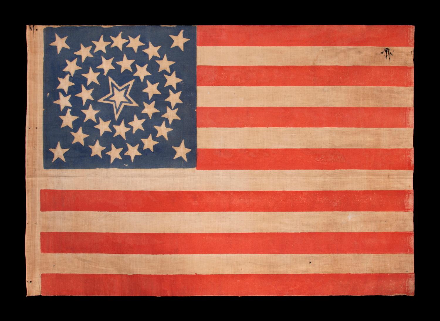 35 stars in a medallion configuration, on an antique American flag of the civil war period, with a large, haloed center star, 1863-1865, west Virginia statehood:

35 star American national parade flag, printed on cotton. The stars are arranged in