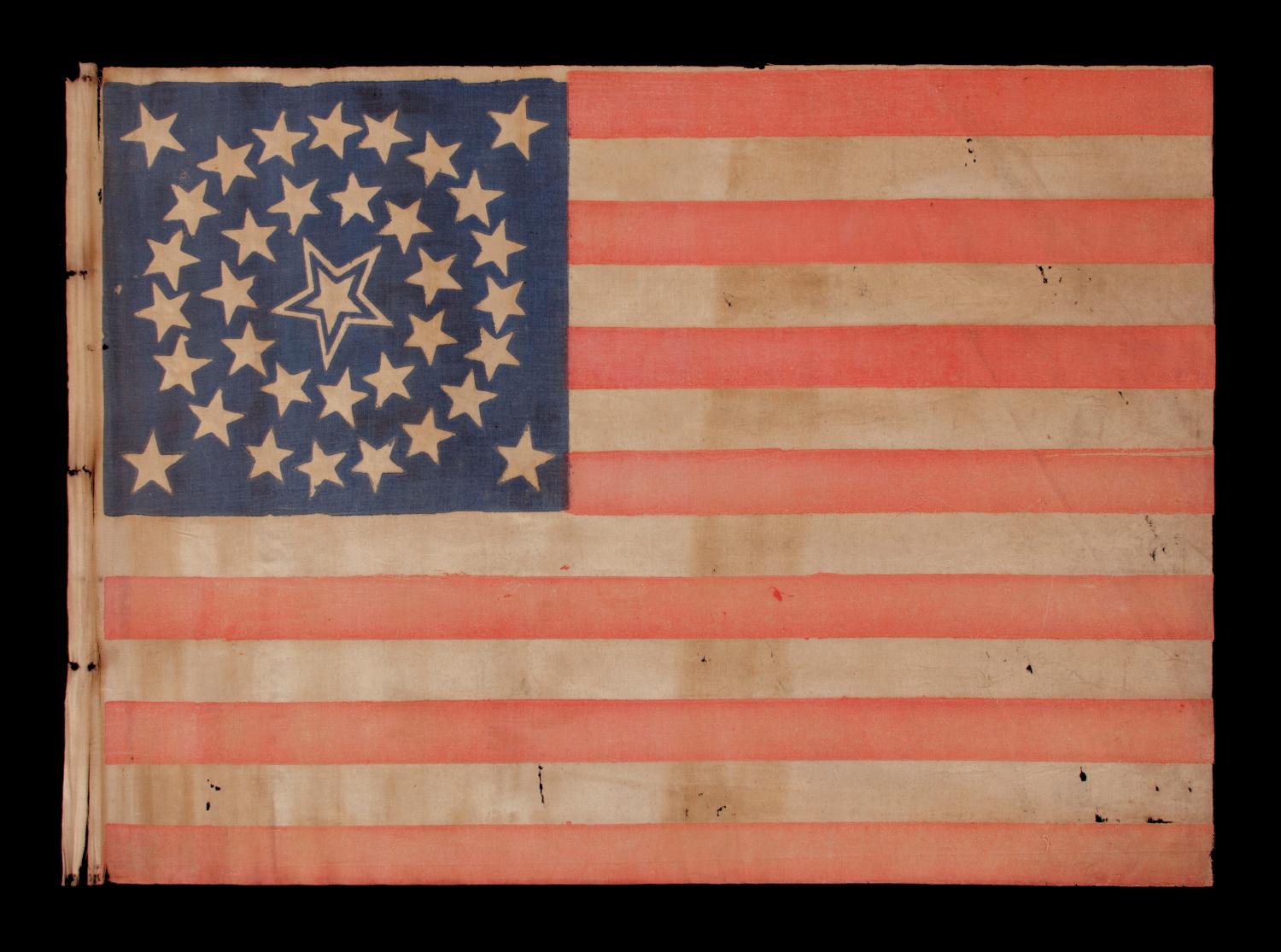 35 STARS IN A MEDALLION CONFIGURATION WITH A LARGE, HALOED CENTER STAR, CIVIL WAR PERIOD, WEST VIRGINIA STATEHOOD, 1863-65 

35 star American national parade flag, printed on cotton. The stars are arranged in what is known as a medallion