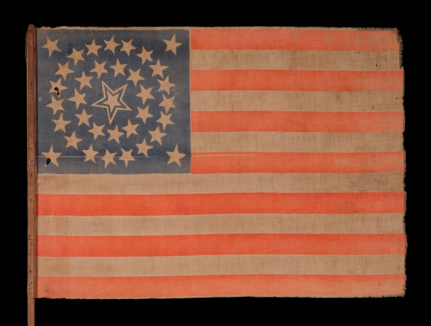 35 STARS IN A MEDALLION CONFIGURATION WITH A LARGE, HALOED CENTER STAR, ON ITS ORIGINAL WOODEN STAFF, CIVIL WAR PERIOD, WEST VIRGINIA STATEHOOD, 1863-65:

35 star American national parade flag, printed on cotton and retaining its original wooden