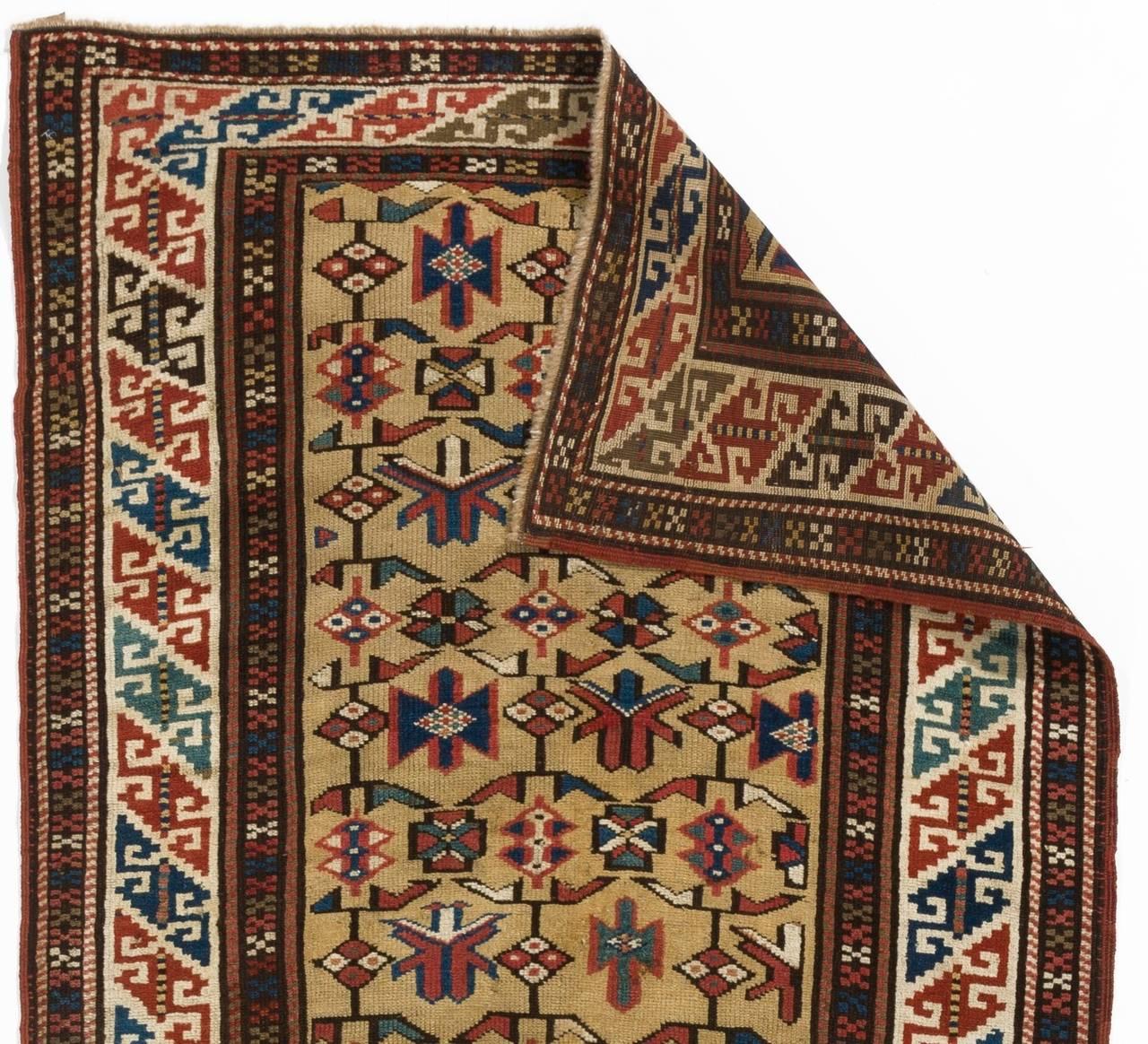 A mid-19th century North East Caucasian rug with a sought after yellow field and beautifully saturated natural dyes. Medium wool pile on wool foundation. Very good condition. Sturdy and as clean as a brand new rug (deep washed professionally).
Size: