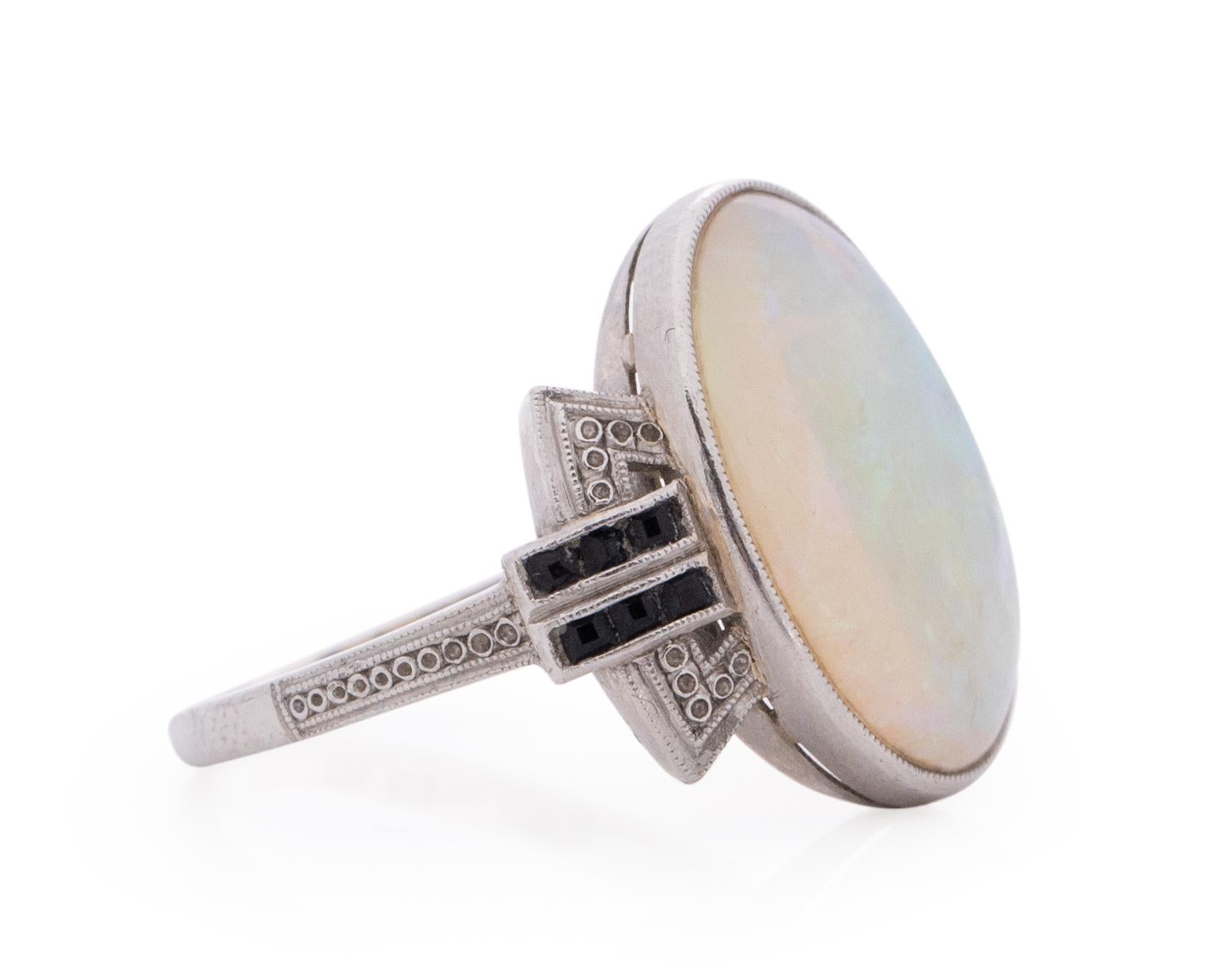Item Details: 
Ring Size: 5
Metal Type: Platinum [Hallmarked, and Tested]
Weight: 2.8 grams

Center Opal Details:
Type: Opal
Weight: 3.50 Carat
Cut: Oval Cabachon

Side Stone Details:
Type: Onyx
Weight: .15 Carat Total Weight
Cut: Antique French