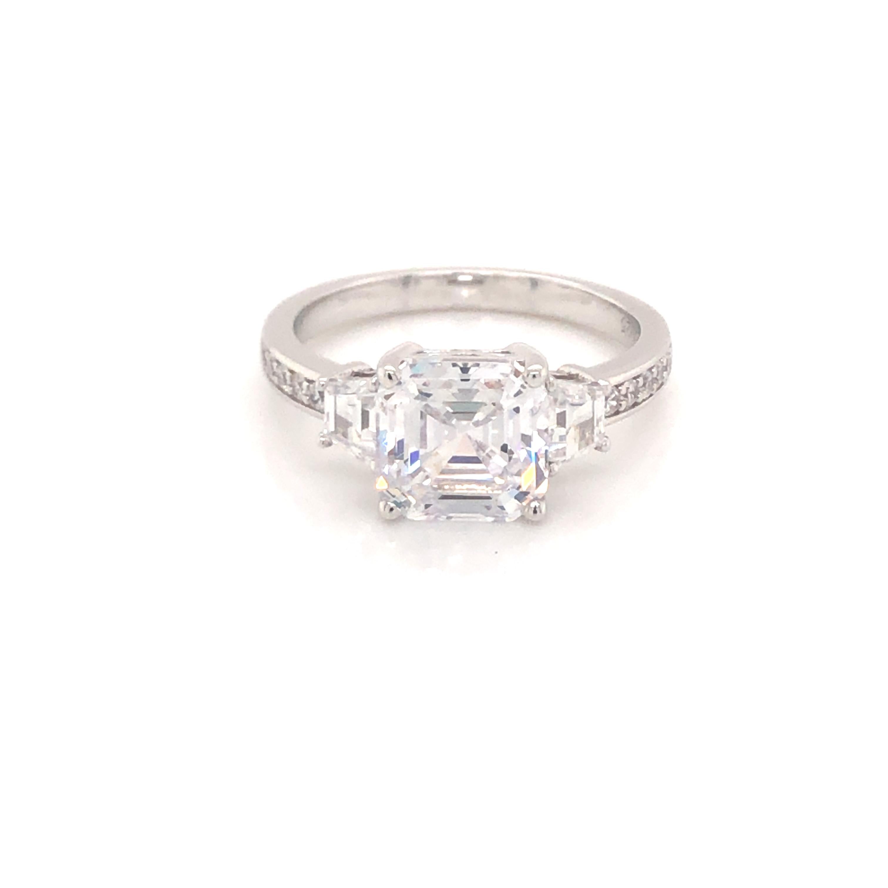 This classic design exudes luxury and natural elegance. 

Featuring a dazzling 3.50ct centre asscher cut cubic zirconia flanked by two tapered princess cuts with five round brilliant cuts on either side. 

Composed of 925 sterling silver with a high