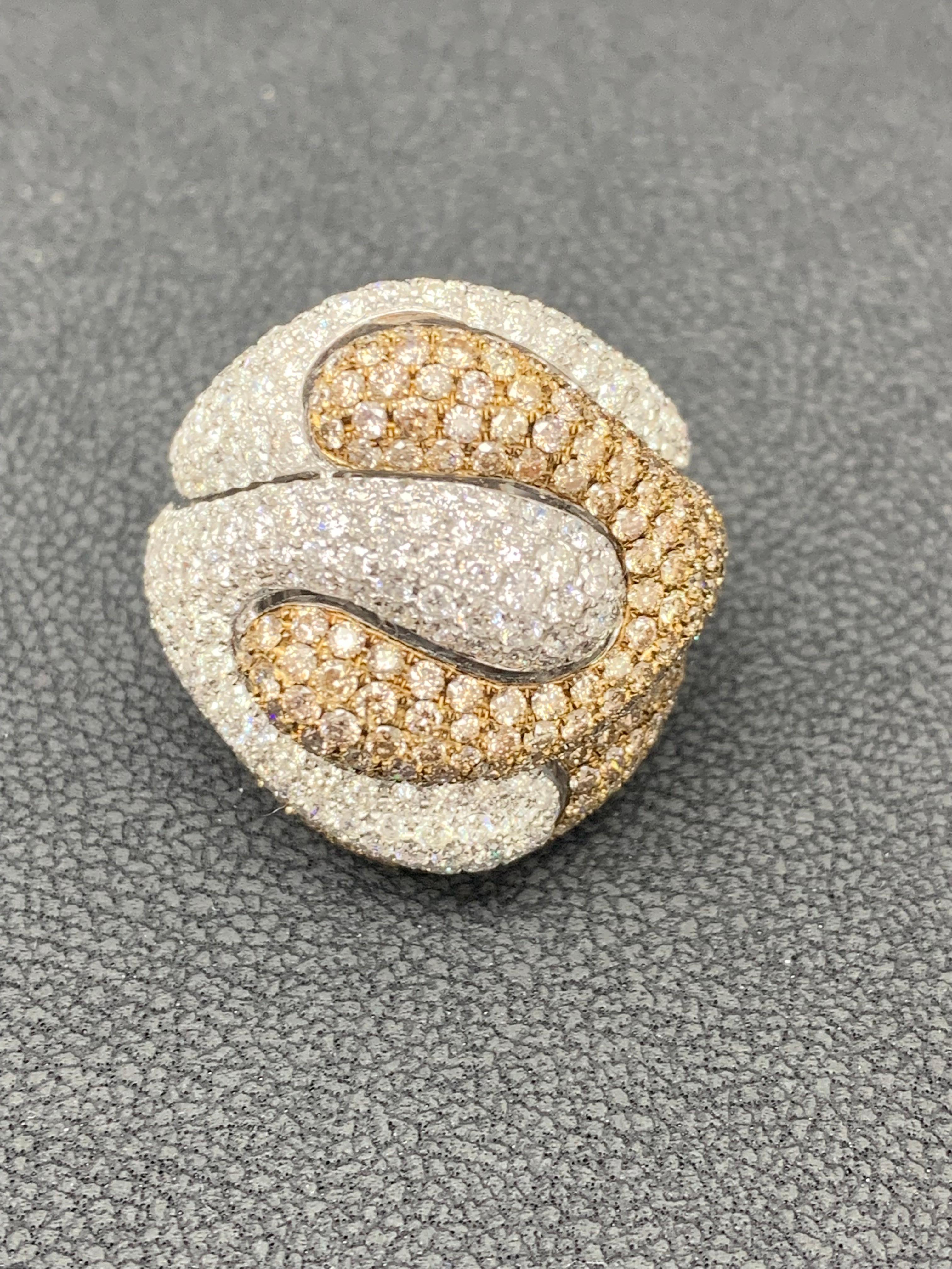 Exquisite Fancy Wide Dome Cocktail Ring is adorned by Natural Fancy Brown Orange Round Cut Diamonds expertly placed
with brilliant round White Diamonds throughout the Dome shape band.  A total 3.50 carat weight of brown diamonds and 3.40 carat