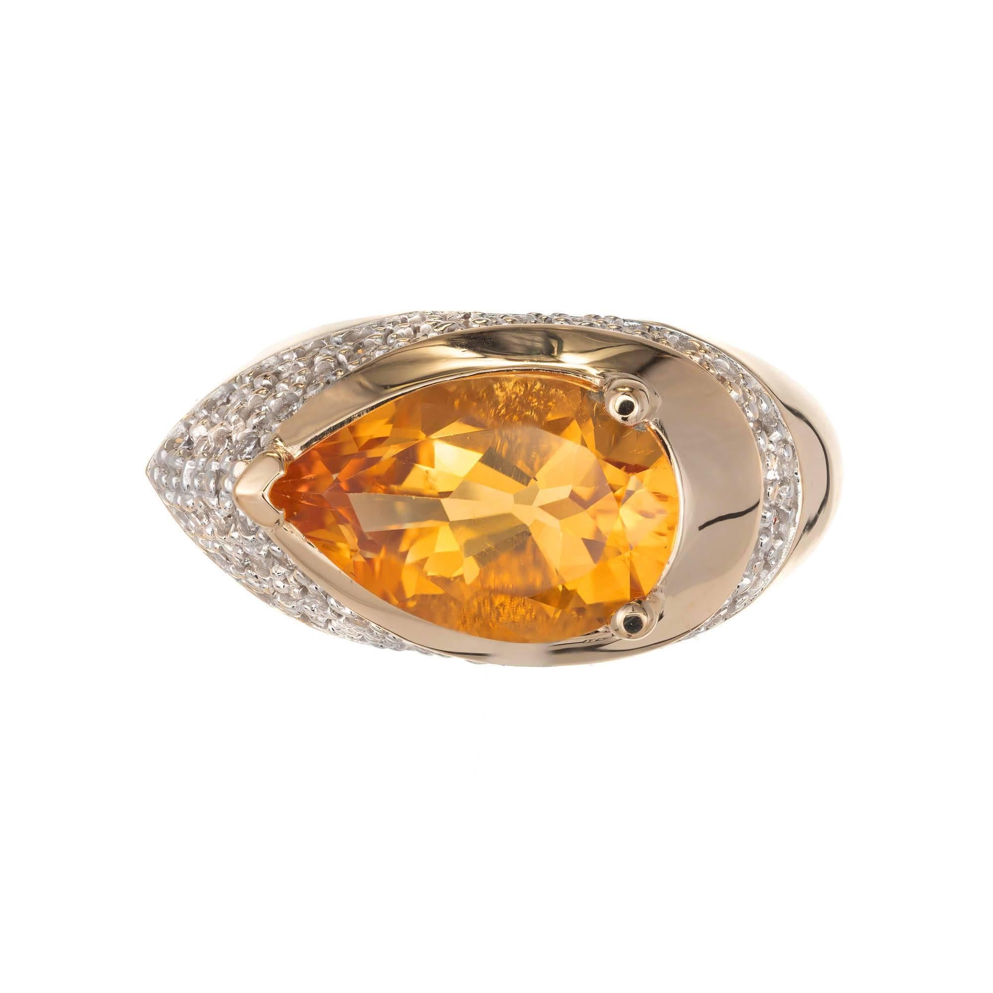 14k yellow and white gold citrine and diamond cocktail ring. Pear shape citrine set in a high dome ring on the horizontal with a wide band of pave set diamonds from the point of wrapping down and behind the curve of the pear citrine getting narrower