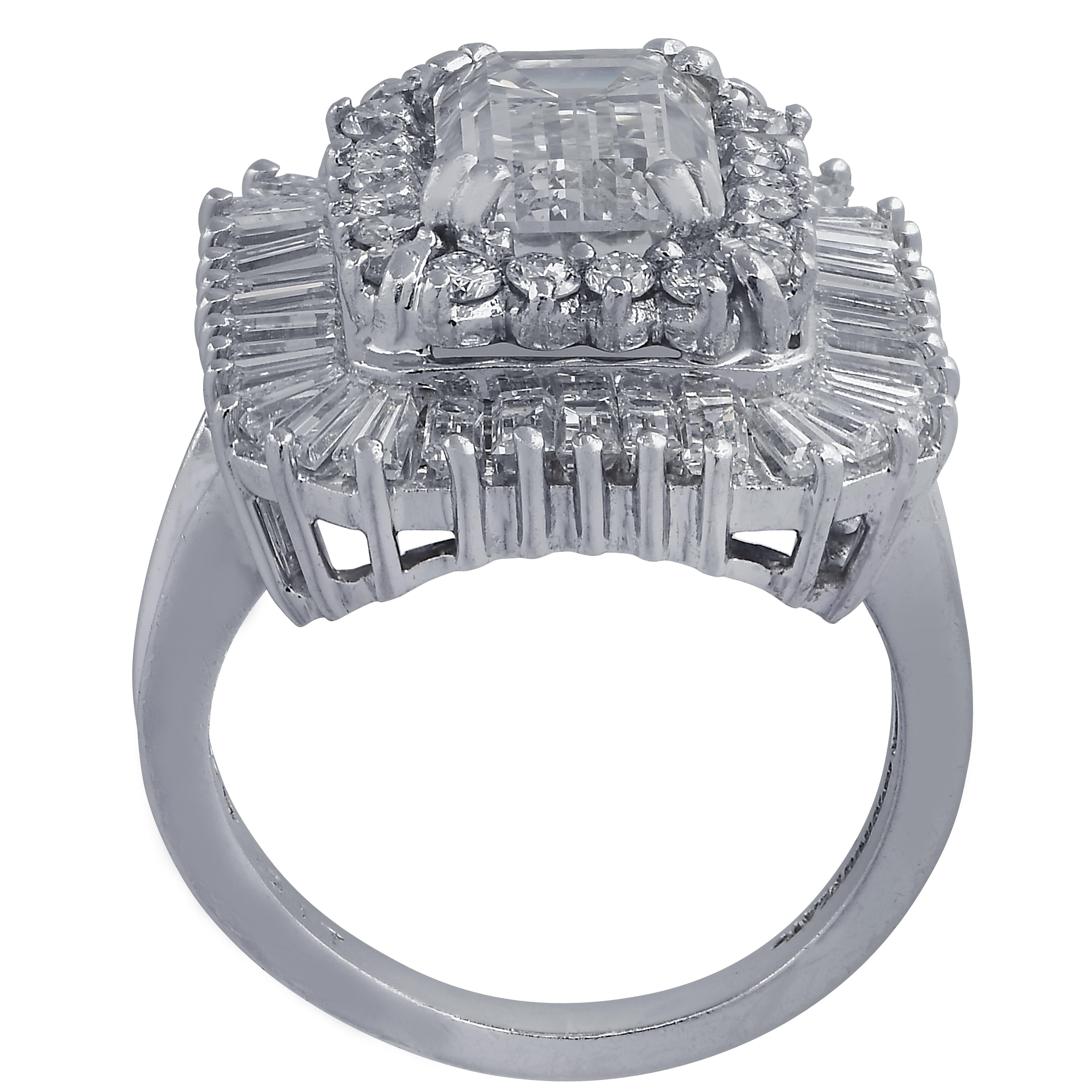 Striking cocktail ring crafted in platinum featuring an emerald cut diamond weighing approximately 3.5 carats, J color, SI clarity, resting on a bed of 59 round brilliant cut diamonds and baguette cut diamonds weighing approximately 2.5 carats