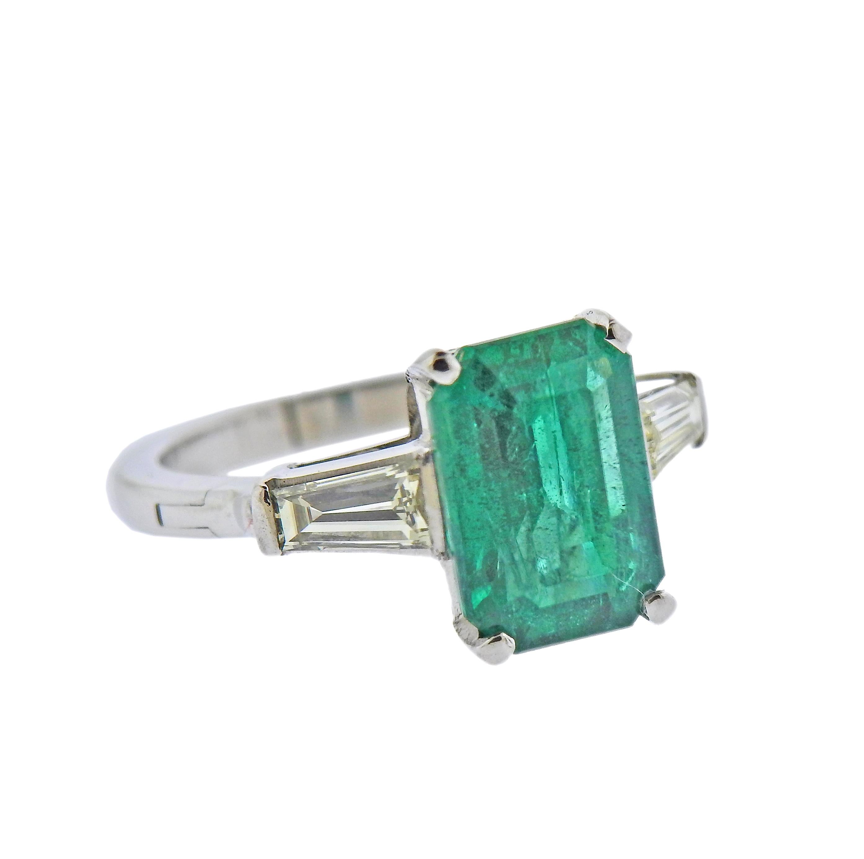 Platinum ring, featuring approx. 3.50ct emerald (measures 11.5 x 8.14 x 5.4mm), set with two tapered baguette diamonds on sides. Arthritis shank, ring size 5.75. Marked Plat (partially polished off). Weight - 6.5 grams.