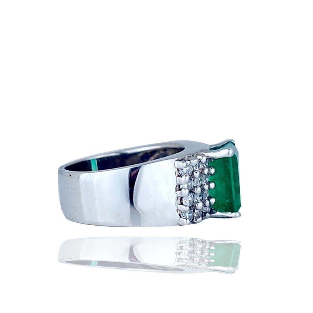 Large 3.50 carat Emerald Diamond Wide Band 18 Karat White Gold Ring 
Large emerald cut prong set emerald is flanked on both sides by 24 prong set round brilliant diamonds 
Emerald measures 10.2 mm x 8.34 mm x 6.8 mm and weighs approximately 3.50