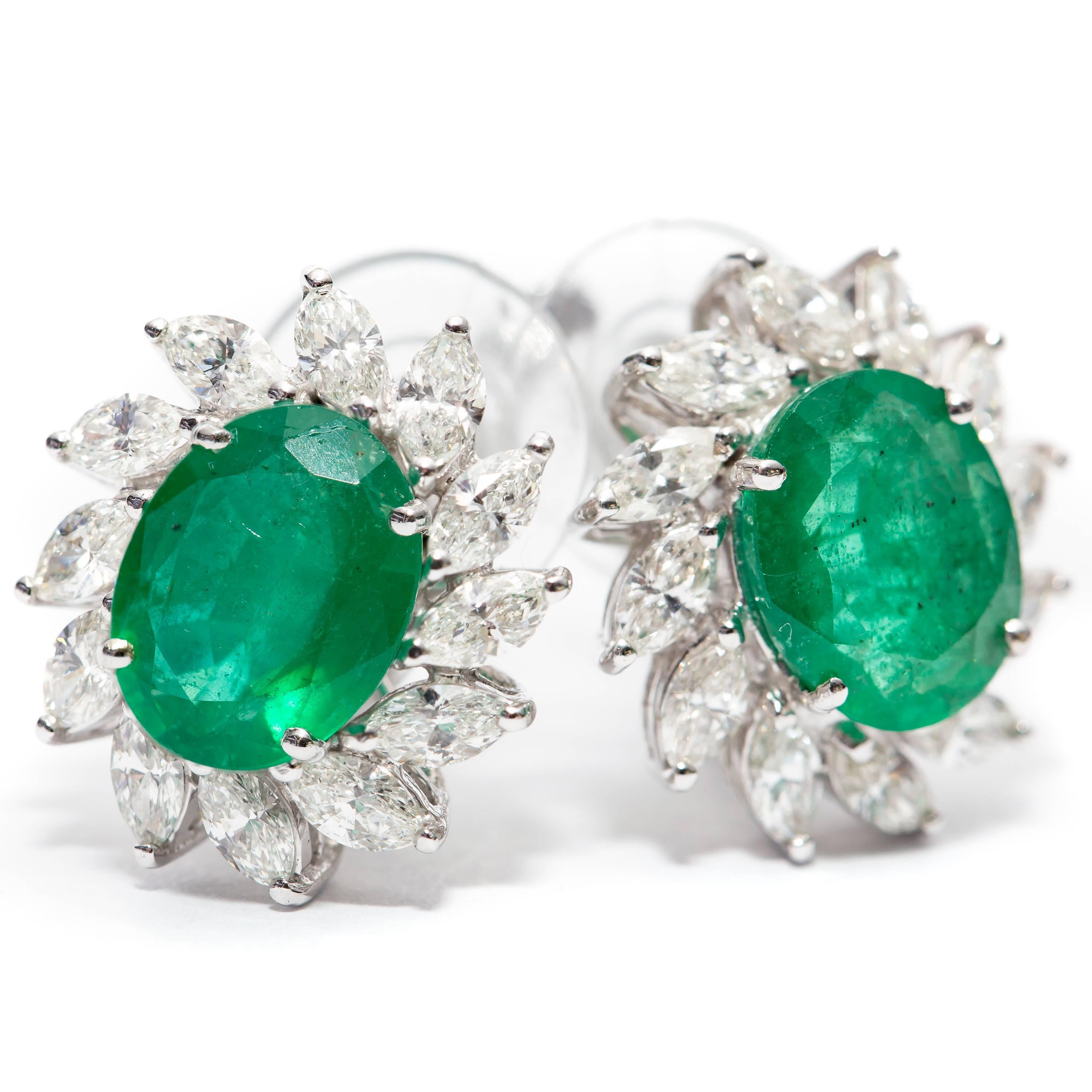 3.50 Carat Emerald Earrings expertly contrasted with the pure radiance of 1.50 Carat Marquise White Diamonds. Set in 18 Karat White Gold these beautiful earrings are perfect for any occasion, and have a recent certificate from EDR (European Diamond