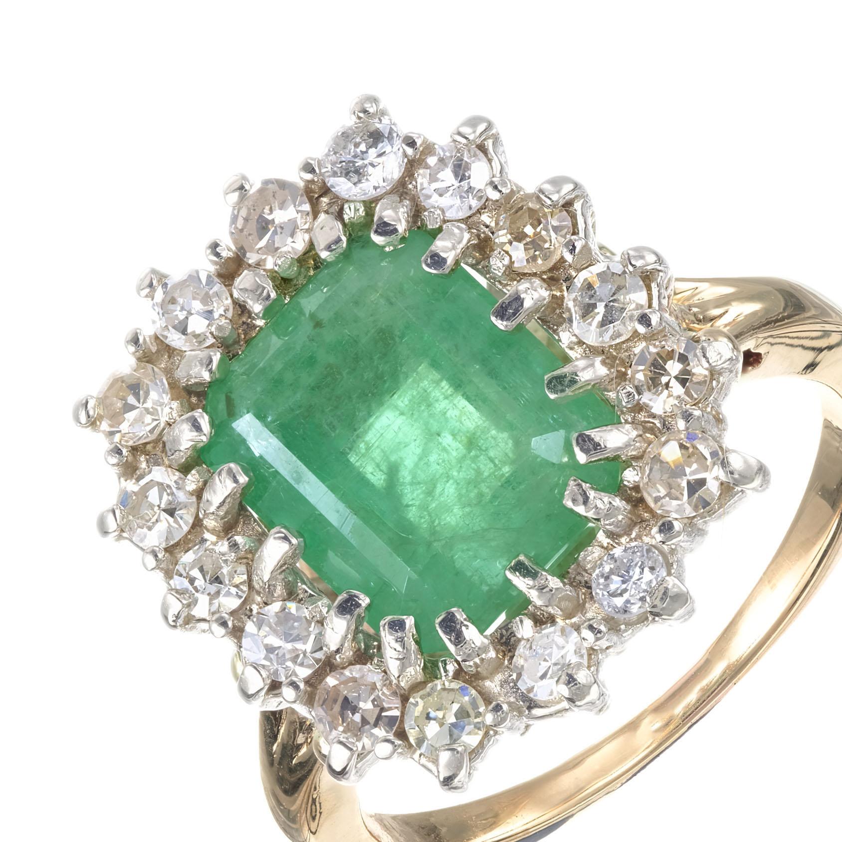 Handmade 18k yellow gold emerald diamond ring. Emerald cut center emerald in a 18 white gold crown with a halo of 16 round diamonds. 18k yellow gold setting. Circa 1940's. 

1 Emerald cut Emerald 10.8 x 8.8mm, approx. total weight 3.50cts
16 round