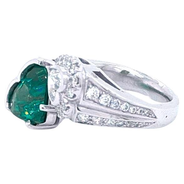 Behold the elegance of this exquisite platinum fashion ring, adorned with a magnificent 3 carat Heart  green vivid emerald and a dazzling 0.50 carat Heart Shape Diamond. The green emerald, delicately heated, takes center stage, cradled in a