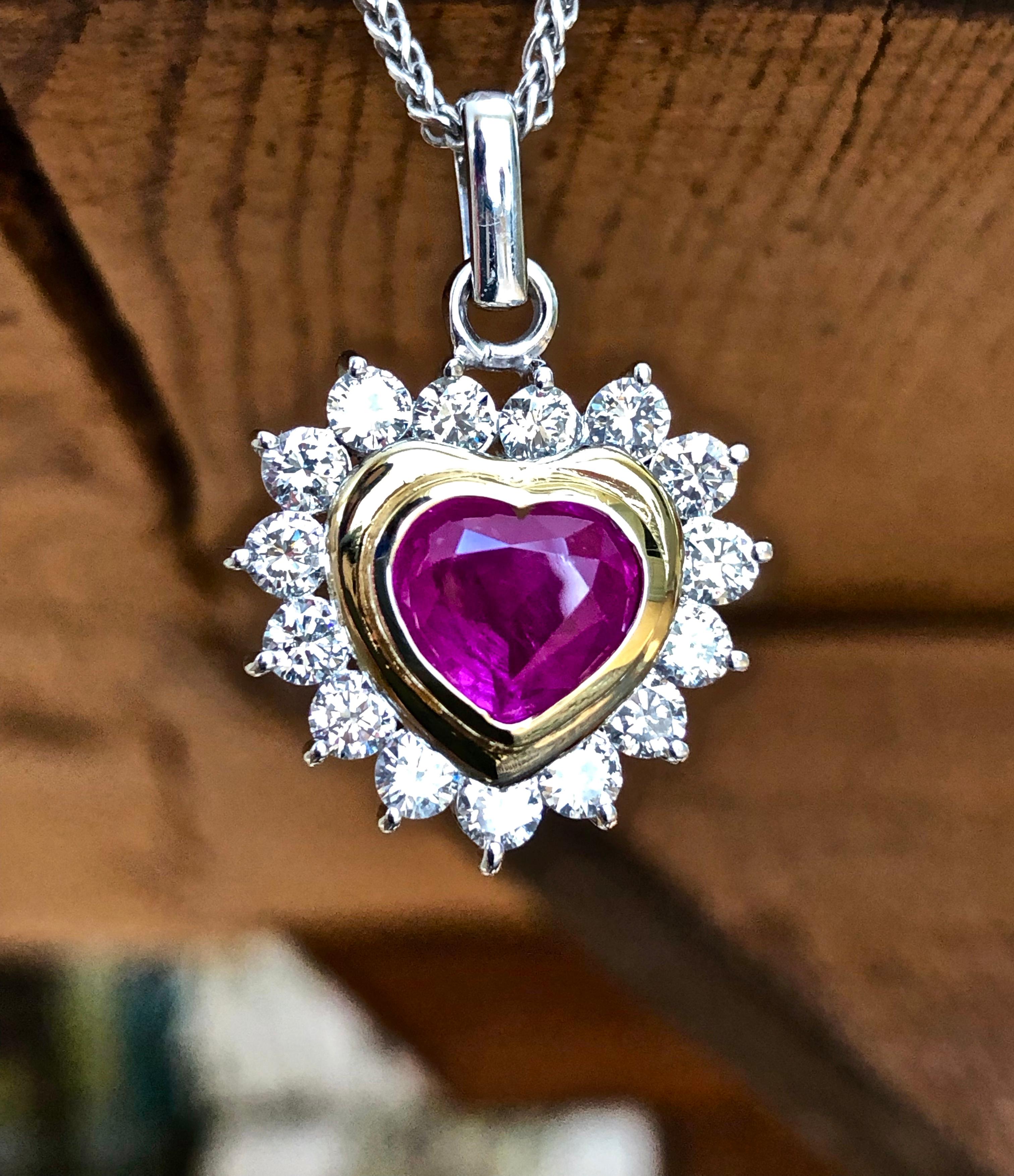 This 2.12 carat heart shape untreated Burma ruby with a rich pinkish red color, set in 18 karat gold with 15 round white diamonds totaling approximately 1.38cts H-SI1. This beautiful ruby-cut heart shape pendant measures 26mmx 18.5mm.
Composition: