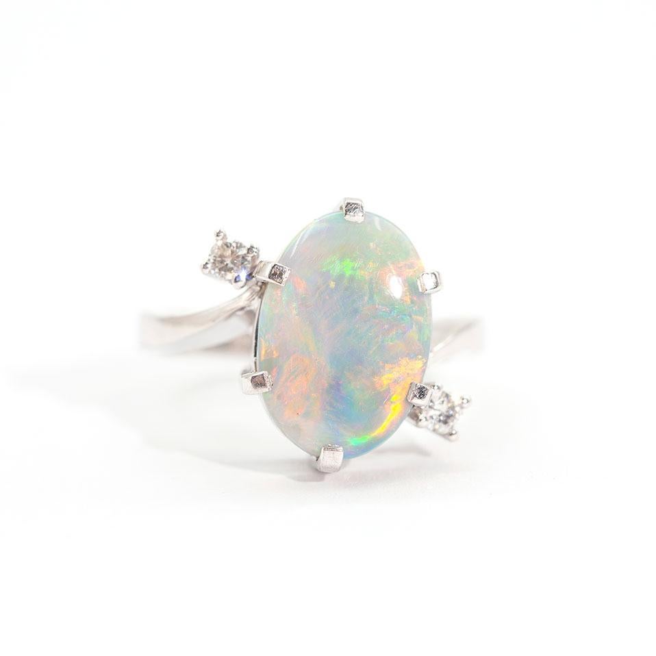 Forged in 18 carat white gold is this handmade enchanting vintage ring featuring a striking 3.50 carat solid oval Australian opal flanked by two round brilliant cut diamonds. We have named this gorgeous vintage piece The Indus Ring. The Indus Ring's