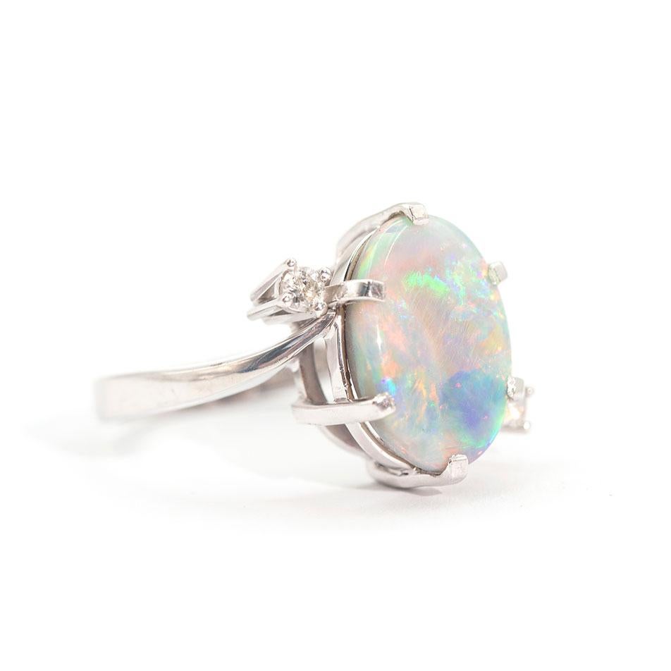 Modern 3.50 Carat Oval Solid Opal and Round Brilliant Vintage 18 Carat White Gold Ring For Sale